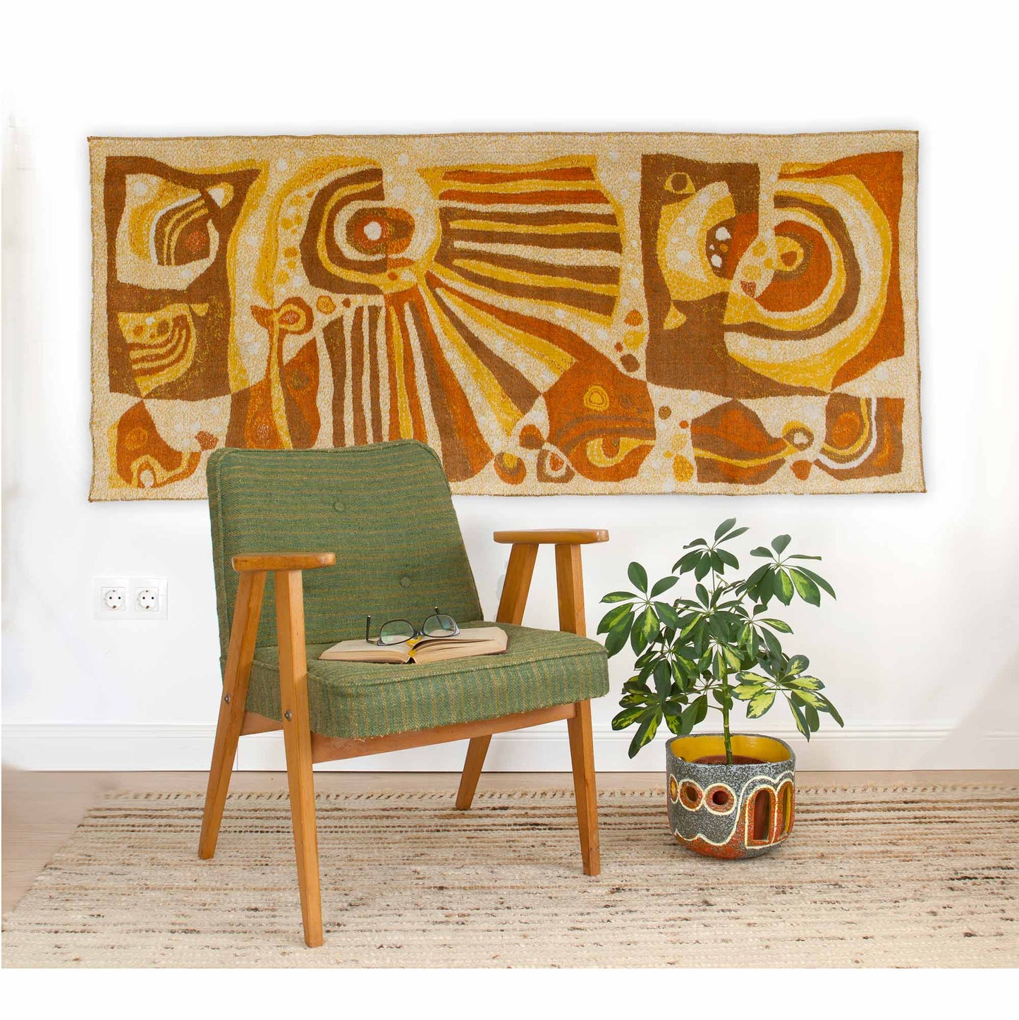 1960s mid century modern wall tapestry styled with a vintage green armchair and a potted plant, large vintage tapestry hanging on the wall with abstract design