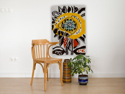 handmade wall tapestry from 1960s, mid century modern wall hanging displayed on the wall behind a vintage dining chair