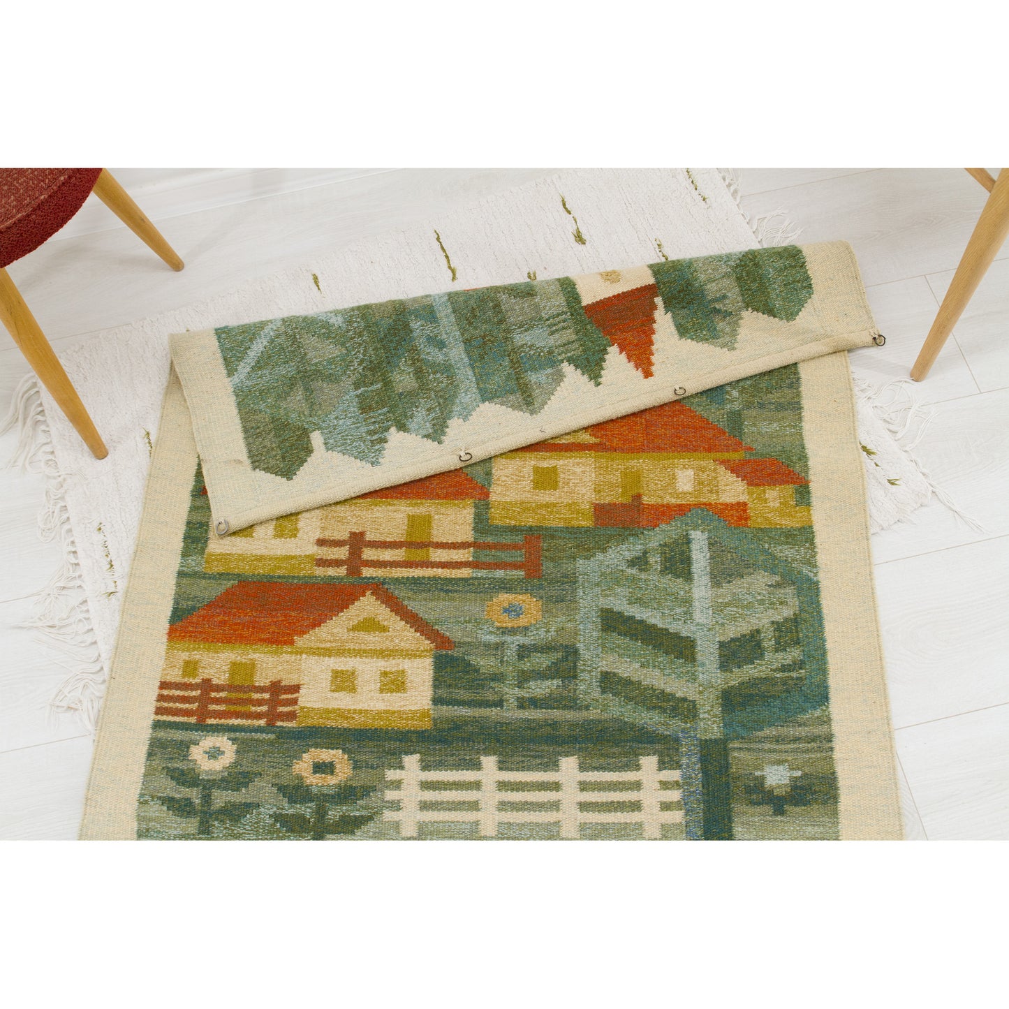 The top edge of the vintage wool hanging is folded over, showing four perfectly placed, hand-sewn metal rings attached to the top hem for immediate mounting.