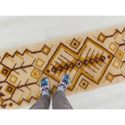 Point of view photography of a person standing playfully on the soft 1970s long hallway floor runner rug, perfectly indicating scale and domestic use.