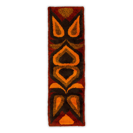 Full vertical view of the stunning vintage 60s rya rug wall hanging. Showcases symmetric tribal and space-age geometry in fiery red, orange, and dark brown.