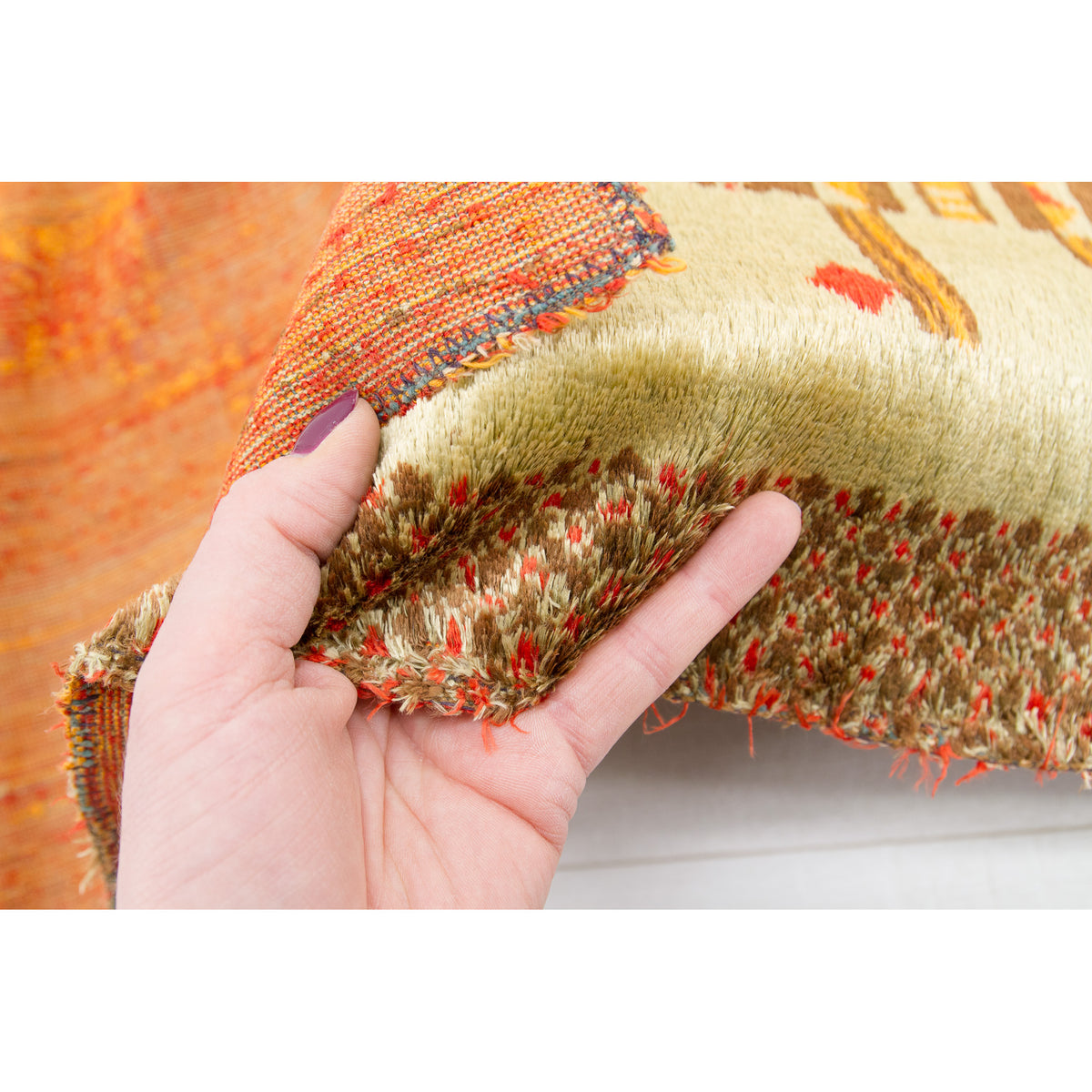 Secondary close-up inspecting the lush green abstract piles and authenticating minor, expected vintage pile wear situated subtly by the very bottom hem.