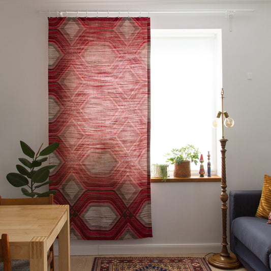 Full length 1970s geometric curtain panel in red and grey hanging in a retro living room