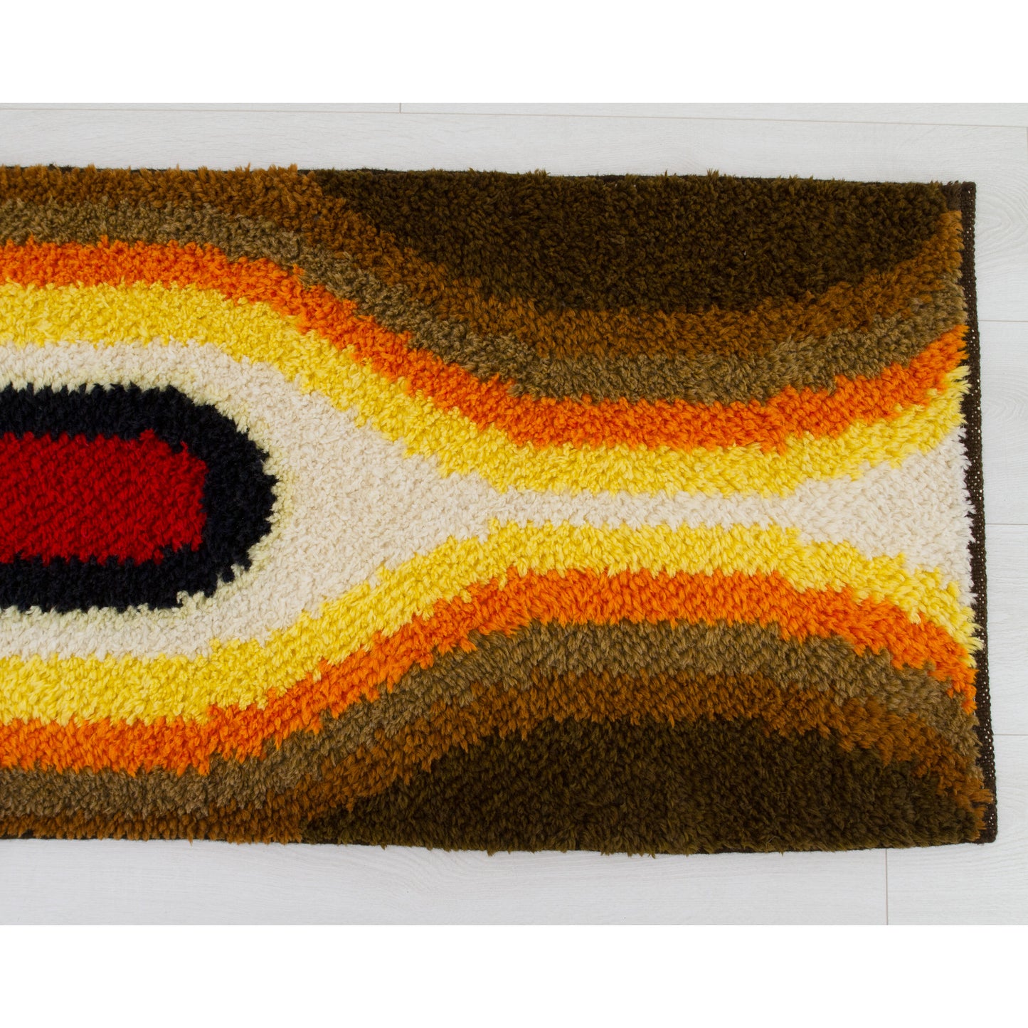 Vintage op-art style shag rug with a striking, bold design. Eye-catching accent piece that is suitable for floor use and wall hanging alike. 