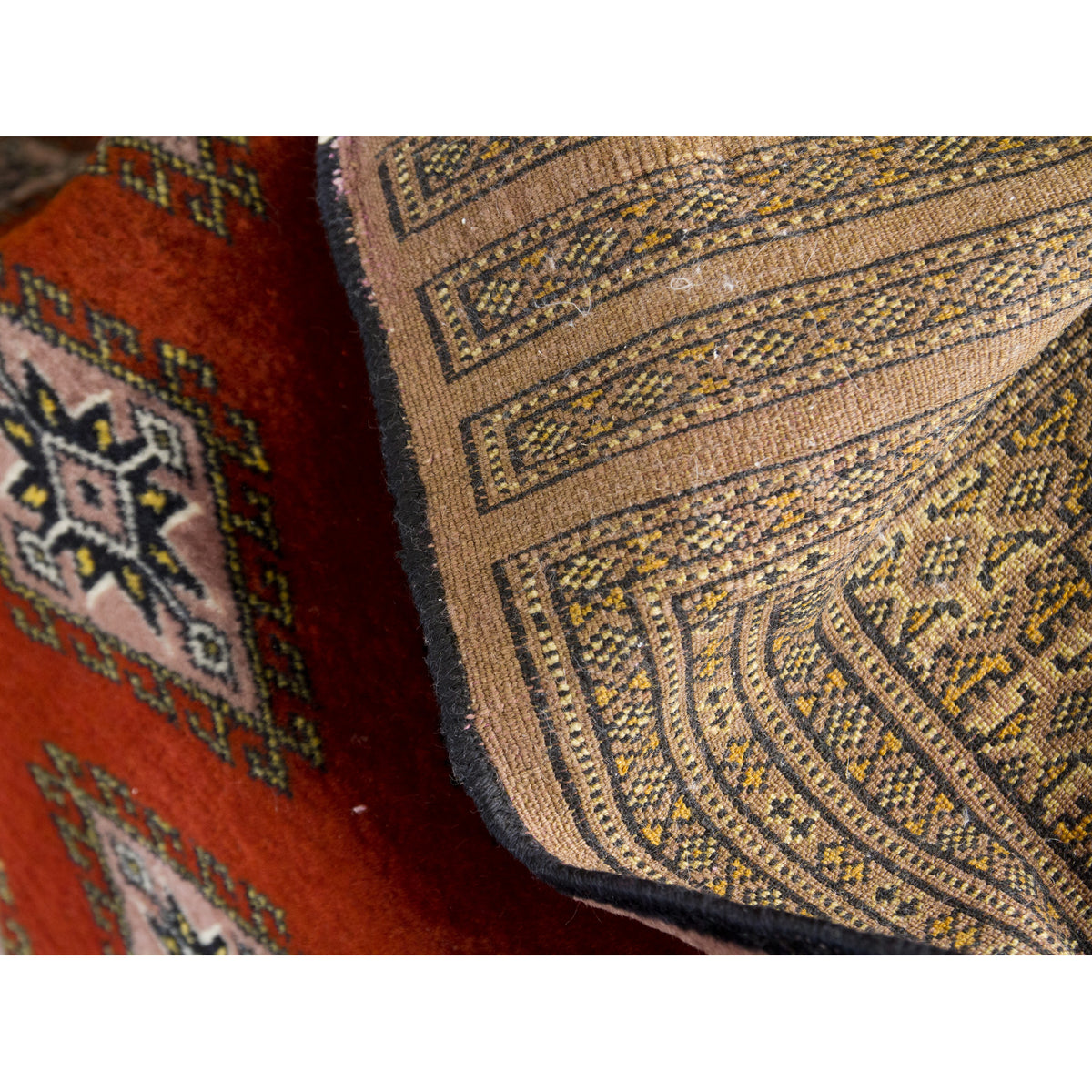 Front and back of vintage Bokhara rug, the clear pattern on the back shows it is hand knotted