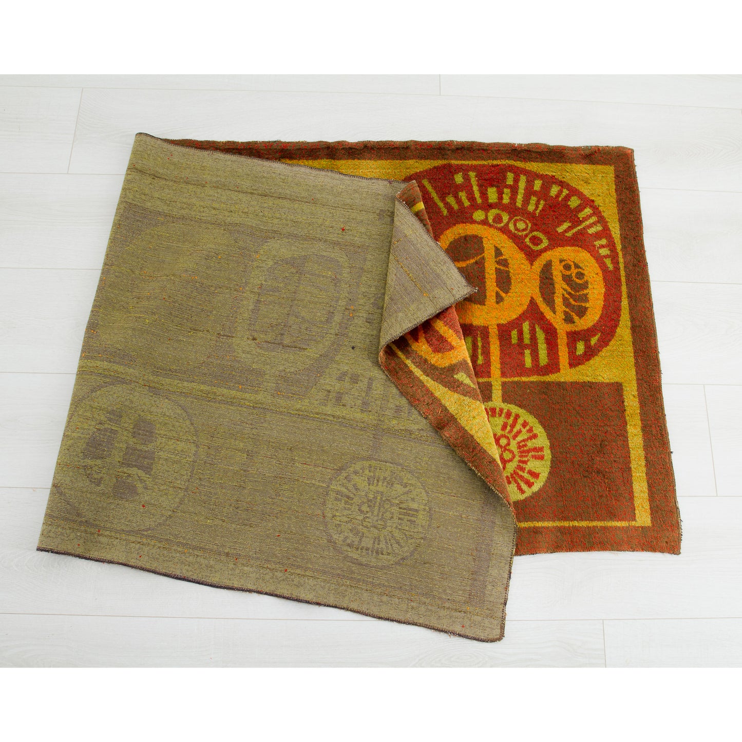 The tapestry folded elegantly on a white floor, acting as a visual quality check that proves it is thoroughly cleaned and free of stains or odors.