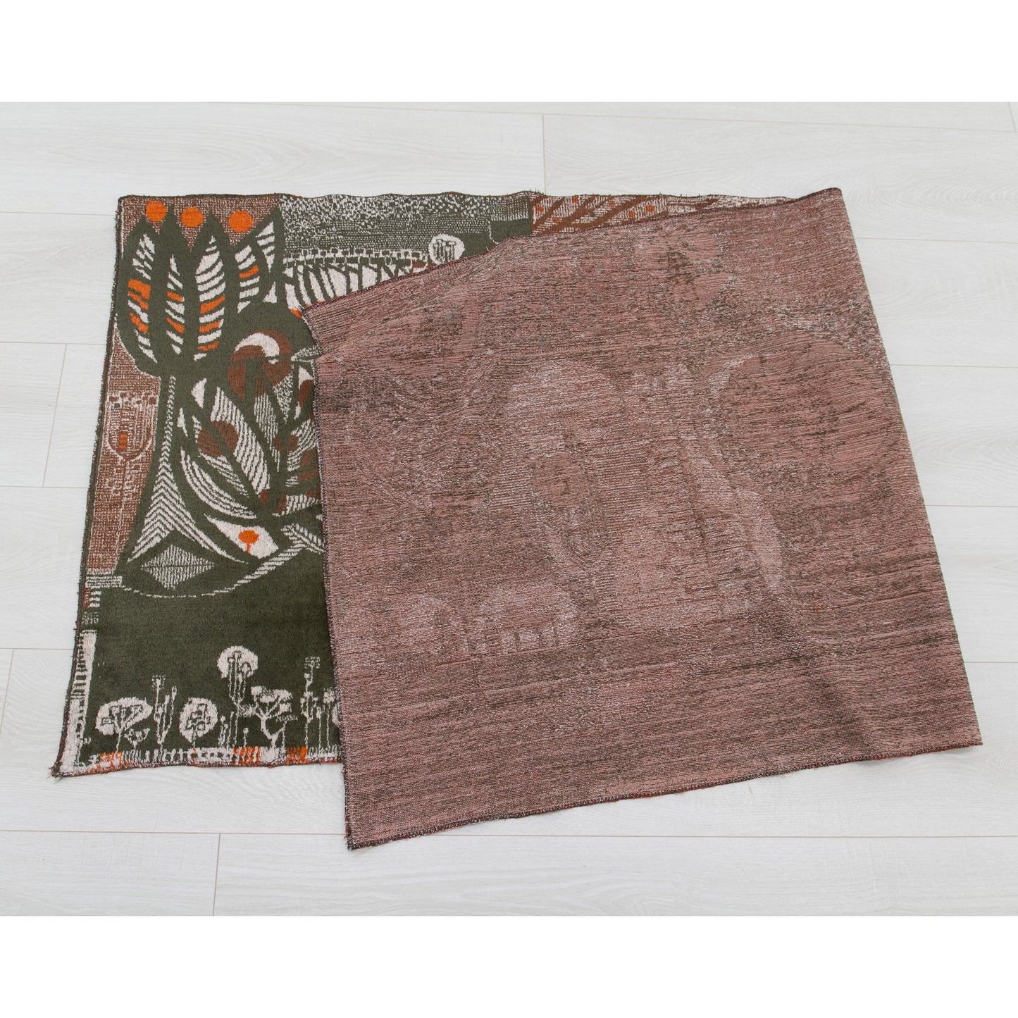 The 1960s vintage wall hanging folded neatly in half on a white floor to verify pristine, spotless condition on both the front display surface and the rugged woven underside. Completely damage-free.