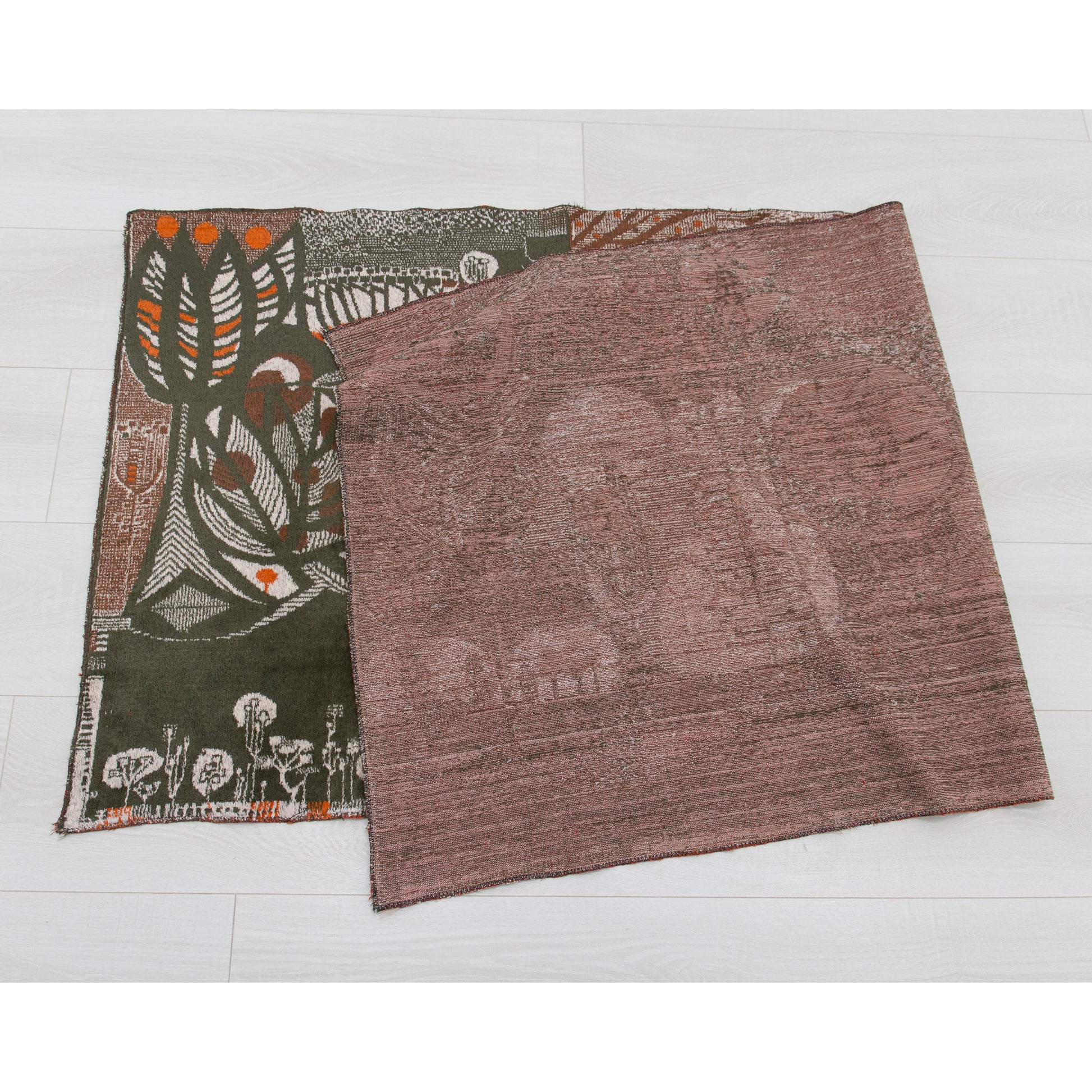 The 1960s vintage wall hanging folded neatly in half on a white floor to verify pristine, spotless condition on both the front display surface and the rugged woven underside. Completely damage-free.
