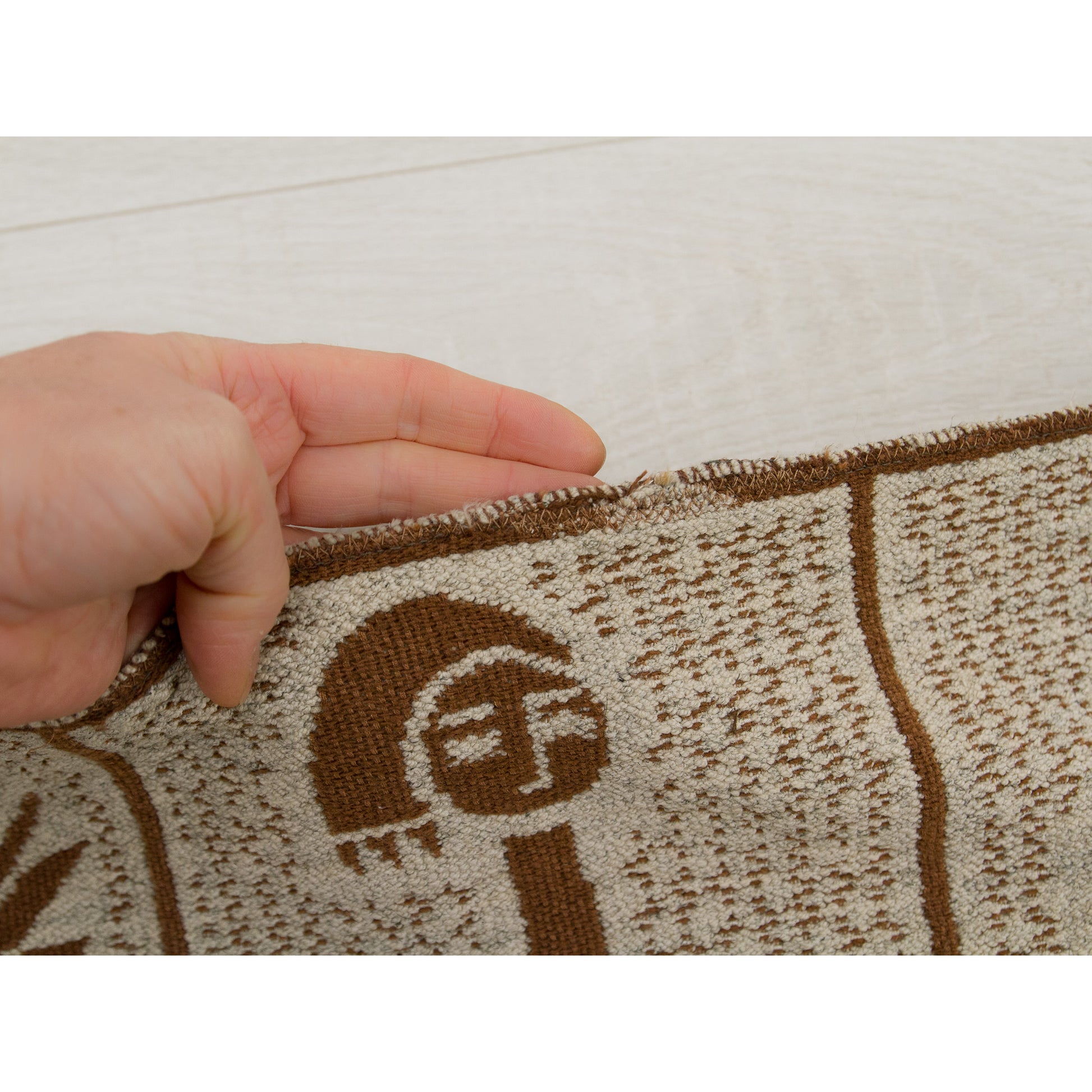Historical mending along the edge of the tapestry, showing how valued this decor piece has been.