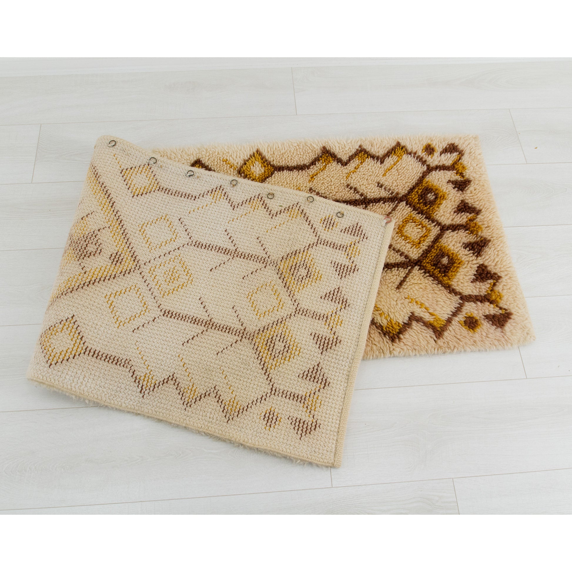 A large portion of the massive runner flipped gracefully back onto itself, revealing an immaculately sturdy, tightly woven natural-colored cotton underside built to survive foot-traffic.