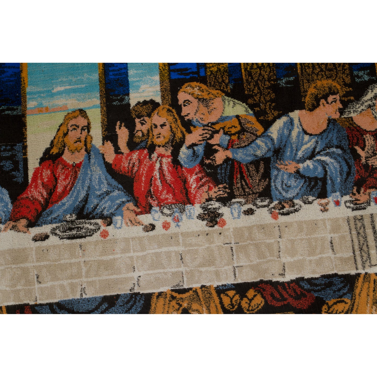 Center macro view isolating the woven image of Jesus Christ and his closest followers gathered behind the famous Last Supper dining table in striking textile relief.