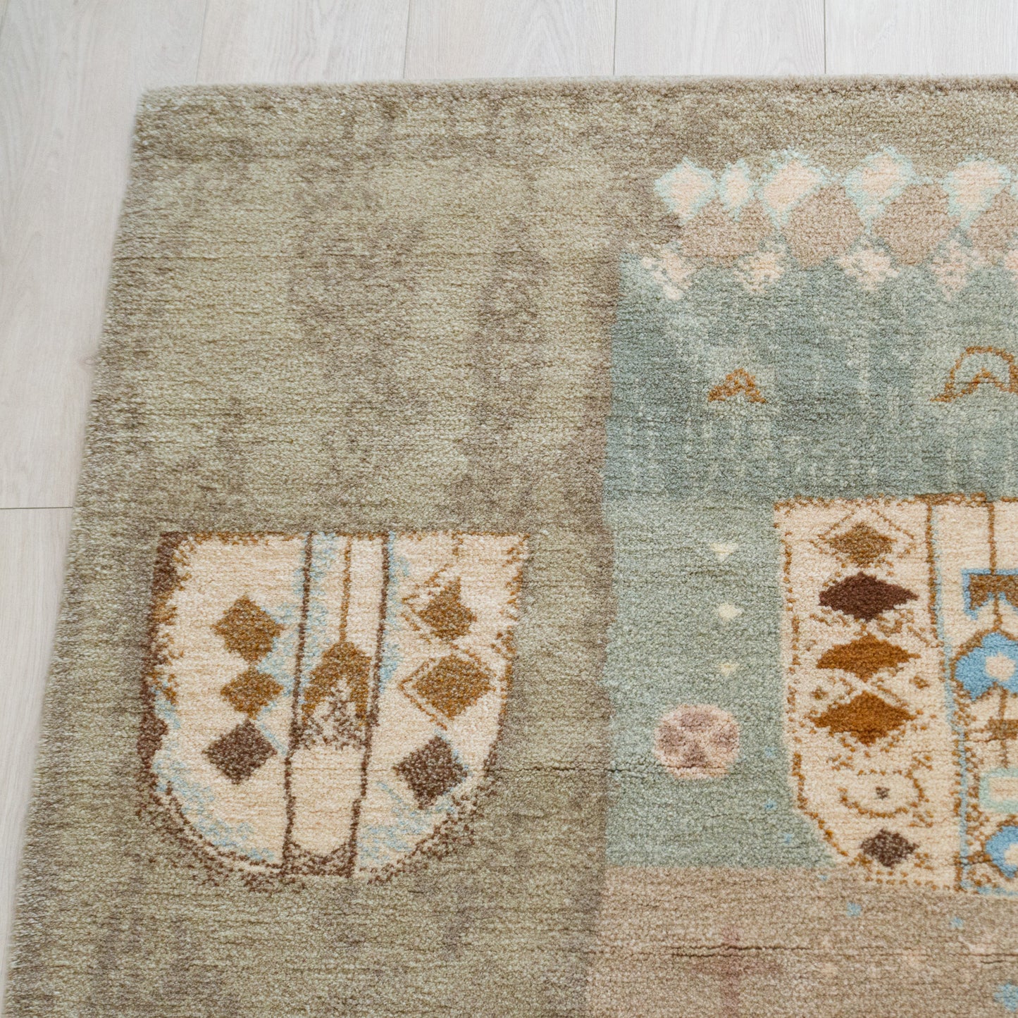 Top left quarter detail of the abstract tapestry showing whimsical drawing-like motifs in pastel blue and soft grey. Authentic mid-century modern Scandinavian inspired design.