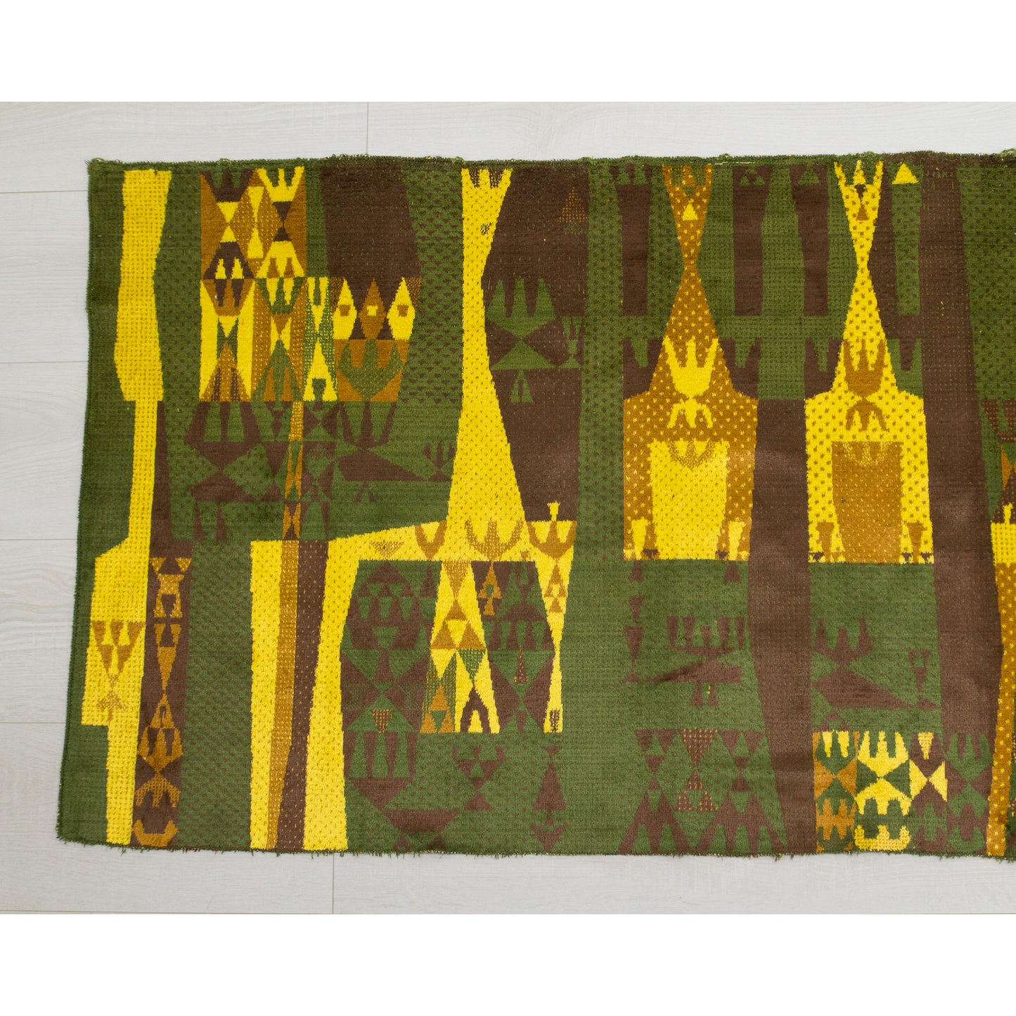 Left side section of the wall hanging showing the trippy, abstract geometric design. High-contrast blocks of bright yellow against deep moss green and chocolate brown.