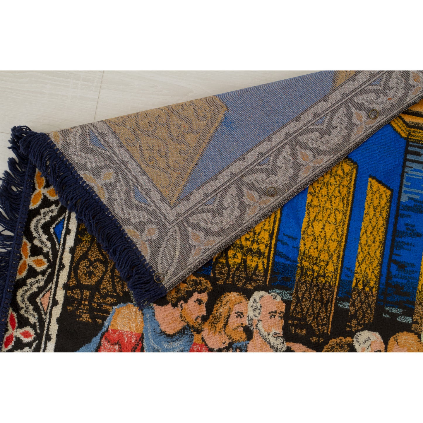 The top left corner of the heavy fabric is gracefully flipped backwards, providing proof of the highly durable, coarse and tight flat-woven foundation that forms the back.
