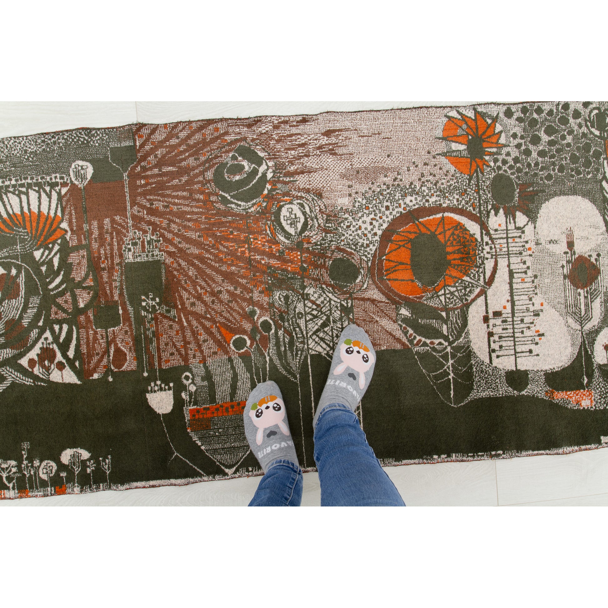 Top-down view showing feet standing on the tapestry, perfectly demonstrating the massive 68.5-inch scale. Sturdy enough to function as an eye-catching accent floor piece in a dark academia or retro living room.