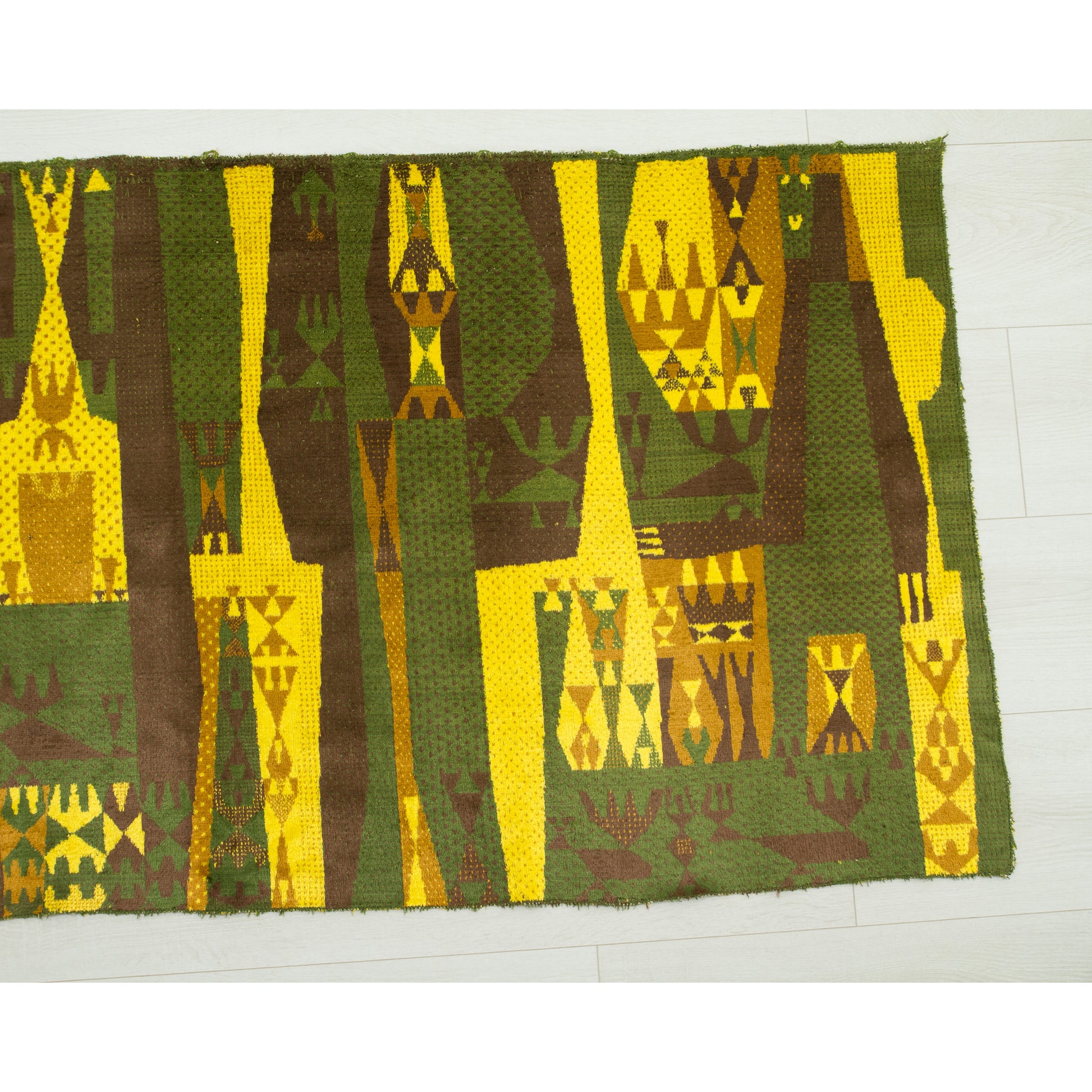 Right section of the wall hanging laid flat, showing the energizing olive green base color contrasting with bright yellow abstract figures. Very typical mid century modern aesthetic from 1960s.