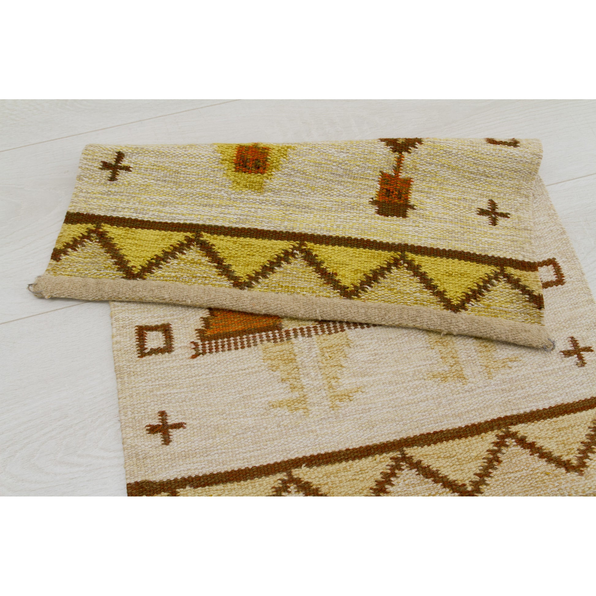 The tapestry laid flat on the floor with its top section folded over, proving the excellent clean condition and demonstrating that hanging hardware is not attached.