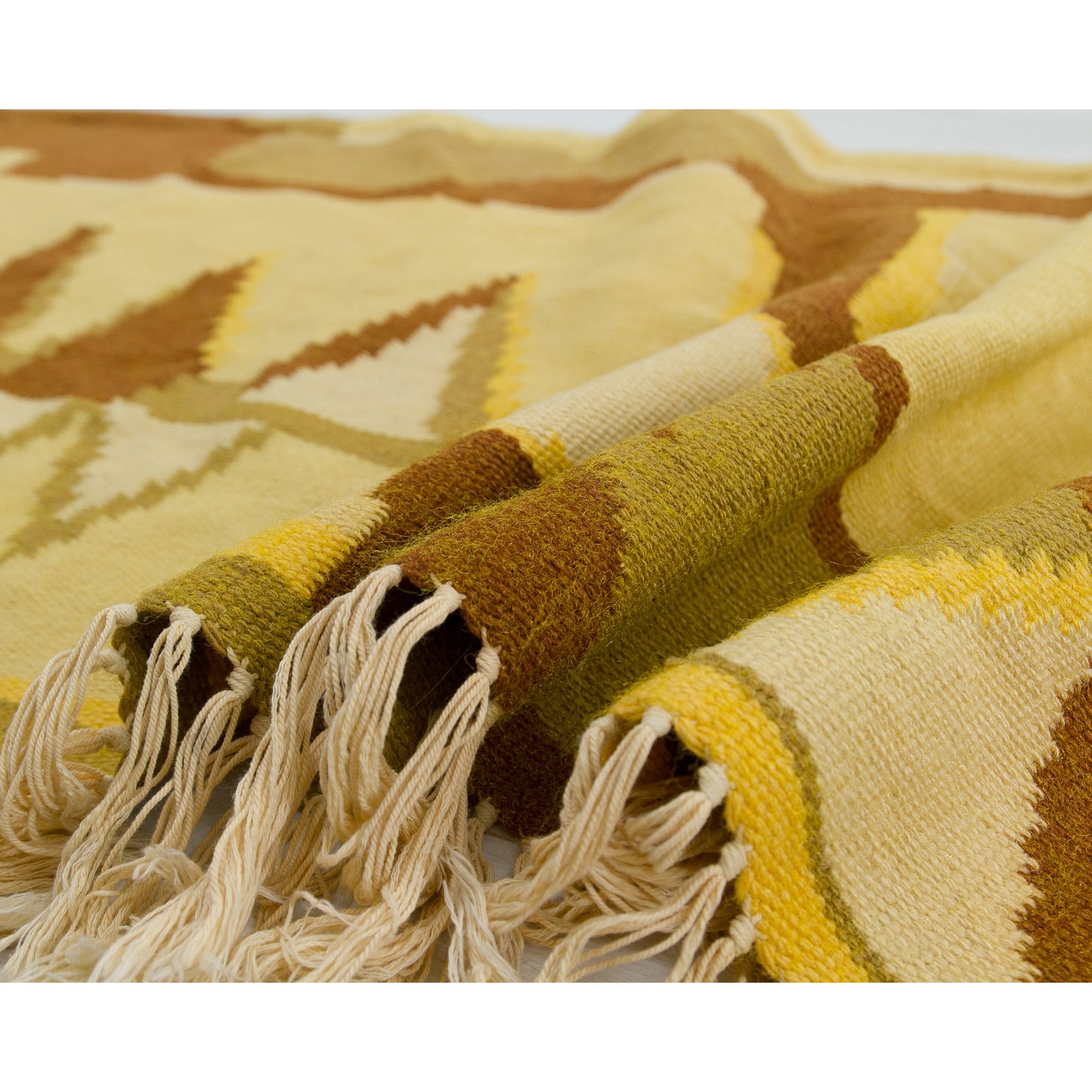 The horizontal tapestry smoothly draped over the floor, emphasizing the movement of the soft fringe and the beautiful drape of the heavy 1.5-kilogram fabric.