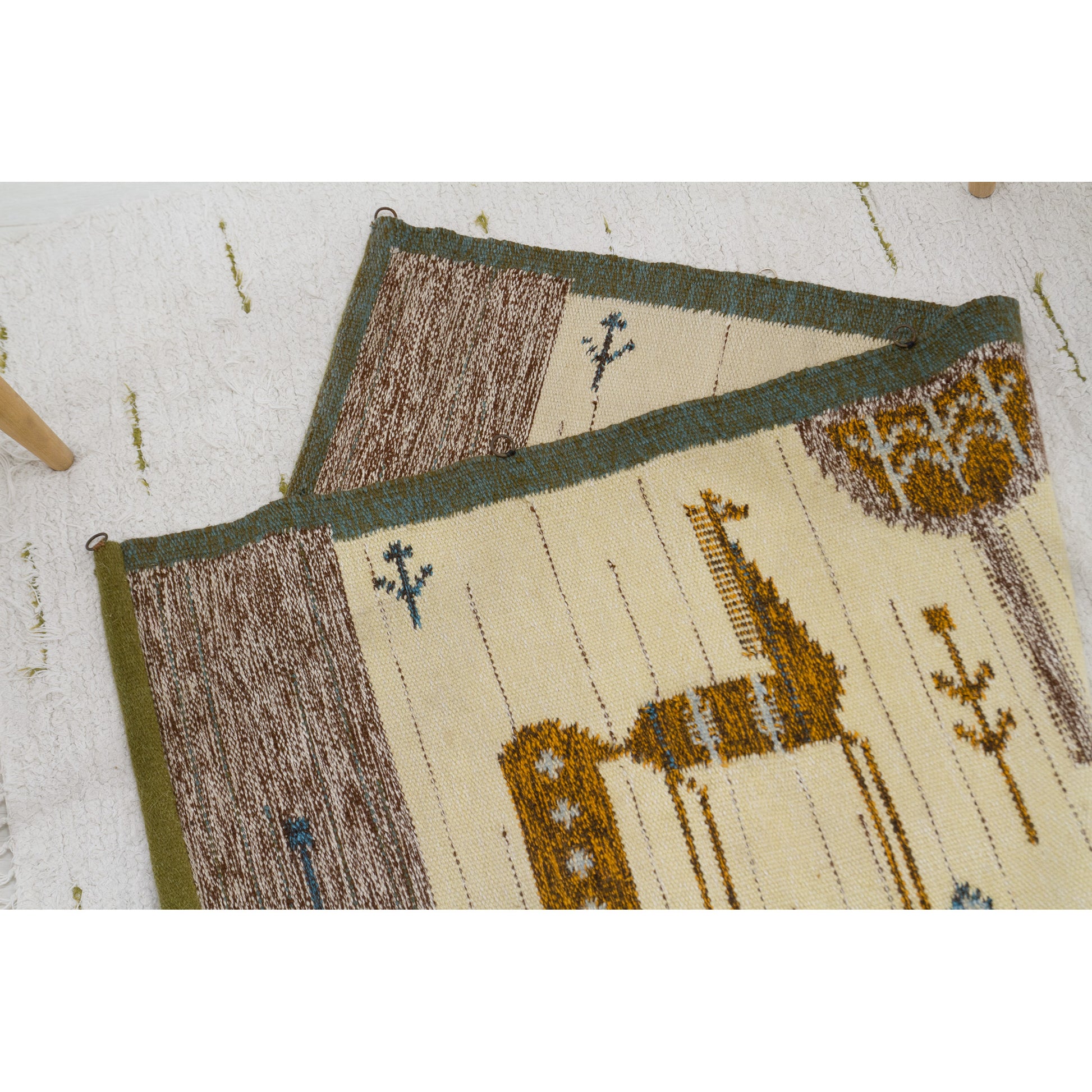 The tapestry is laid completely flat on the floor and halfway folded over upon itself, proving that the vibrant horse pattern is identical and reversible on both sides.