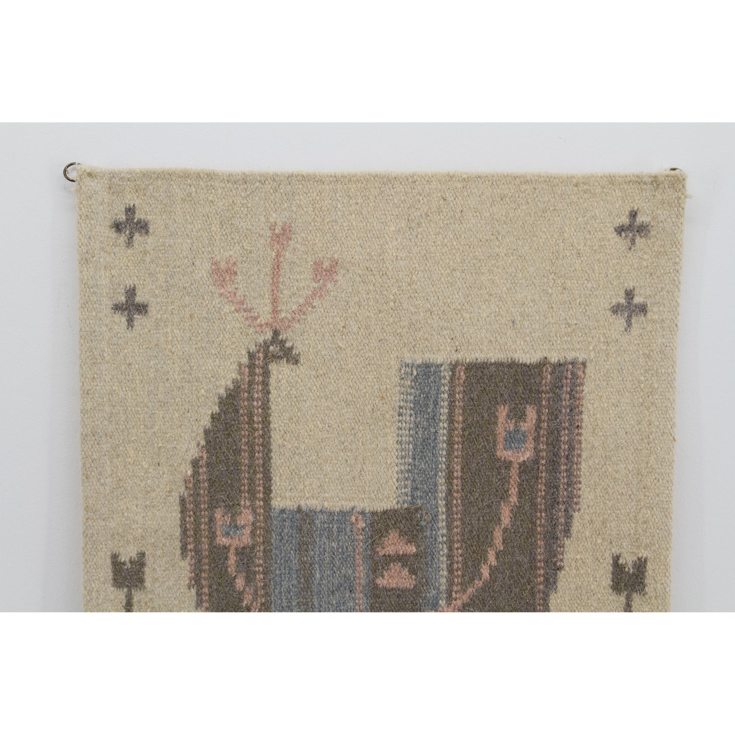 Macro shot of the top segment showcasing the masterfully woven wool rug pattern. Beautiful pastel pink, grey, and soft blue yarns forming Swedish folk art details.