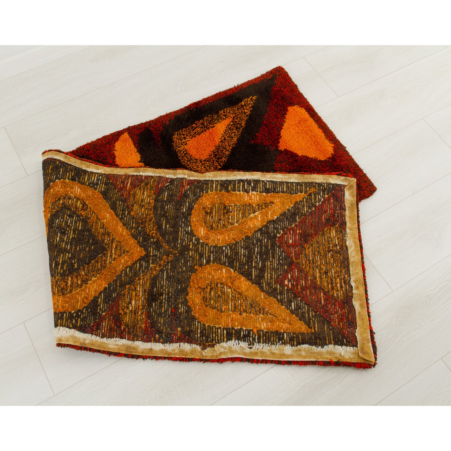 The tapestry neatly folded in half backwards. It clearly exhibits the high-quality backing treated with textile glue specifically applied to seal the tufted knots and prevent shedding.