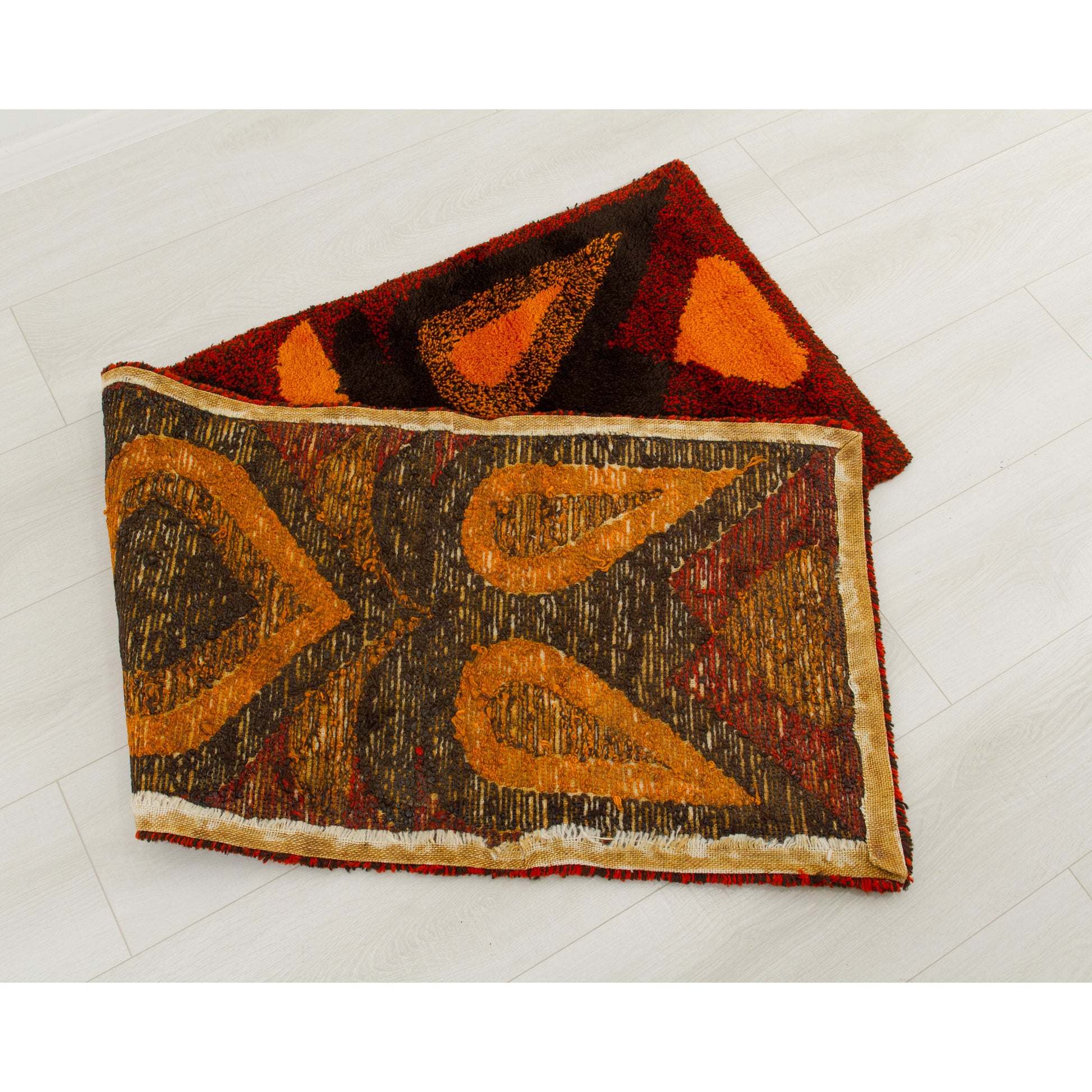 The tapestry neatly folded in half backwards. It clearly exhibits the high-quality backing treated with textile glue specifically applied to seal the tufted knots and prevent shedding.