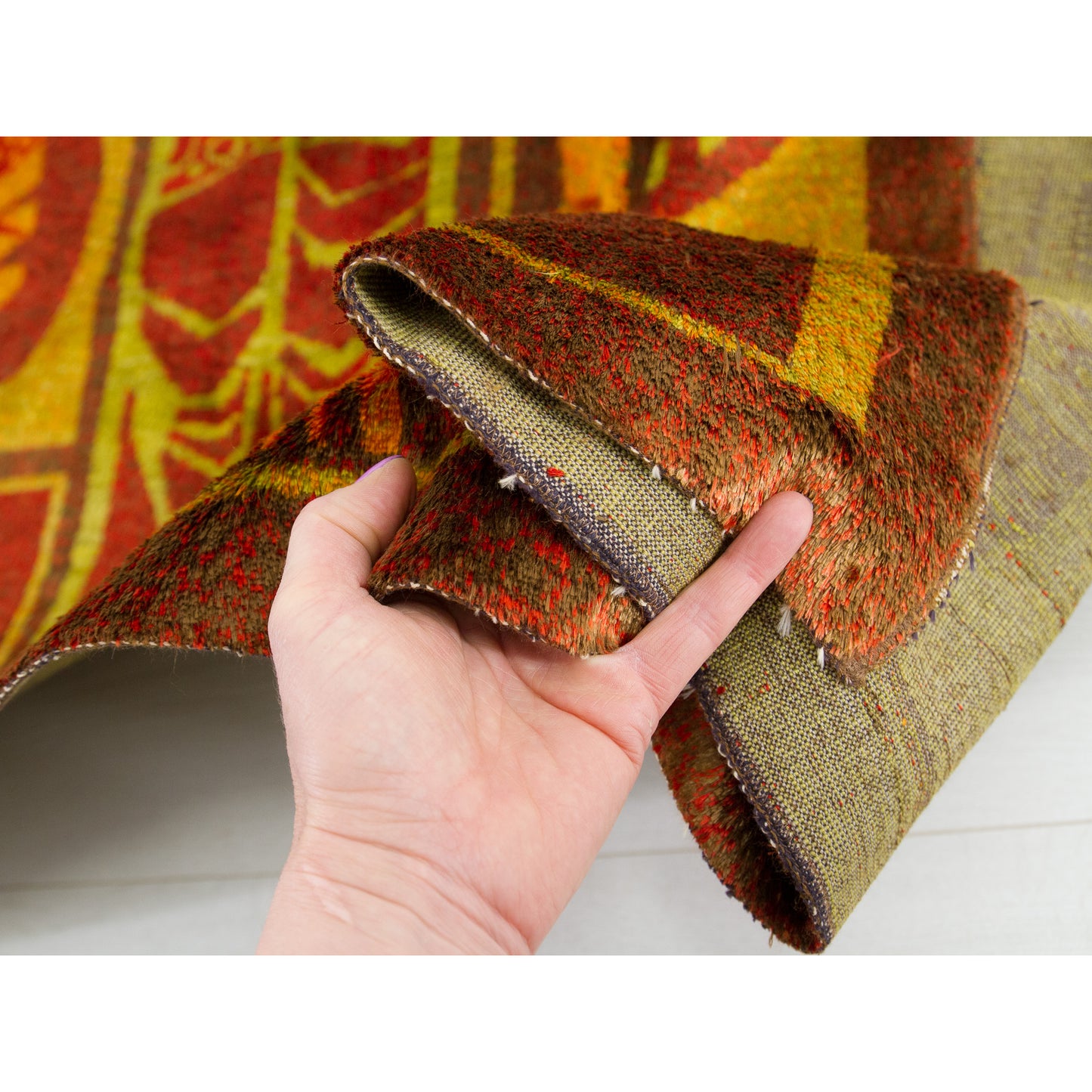 A close-up confirming the secure, professionally bound original woven edge of this 1960s masterpiece. No visible fraying or major vintage damage.