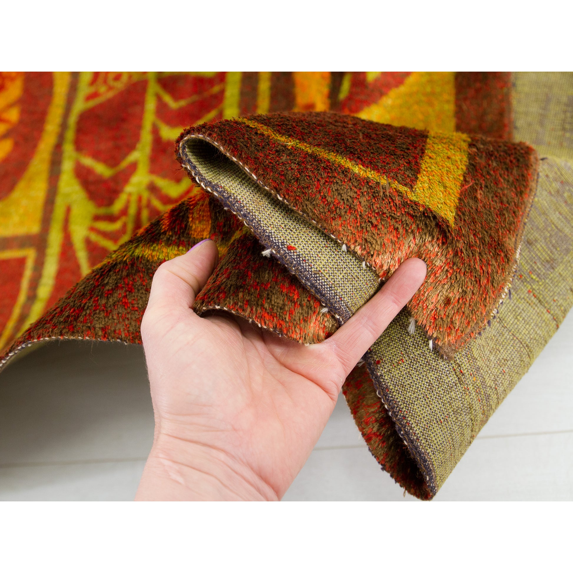A close-up confirming the secure, professionally bound original woven edge of this 1960s masterpiece. No visible fraying or major vintage damage.