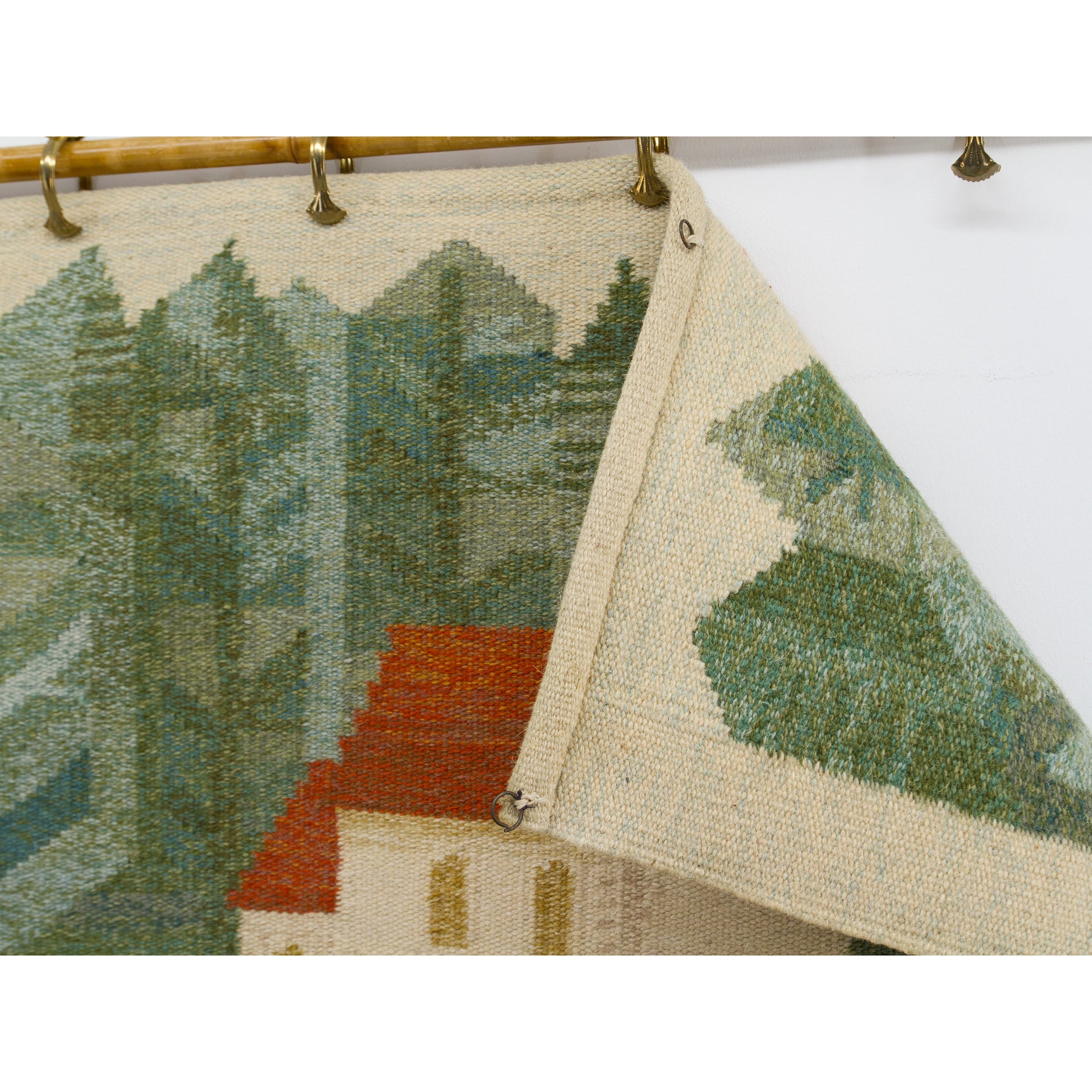 A close-up peek underneath the folded top hem, visually explaining to the buyer how it was smartly staged using simple metal curtain clips on a decorative bamboo rod.