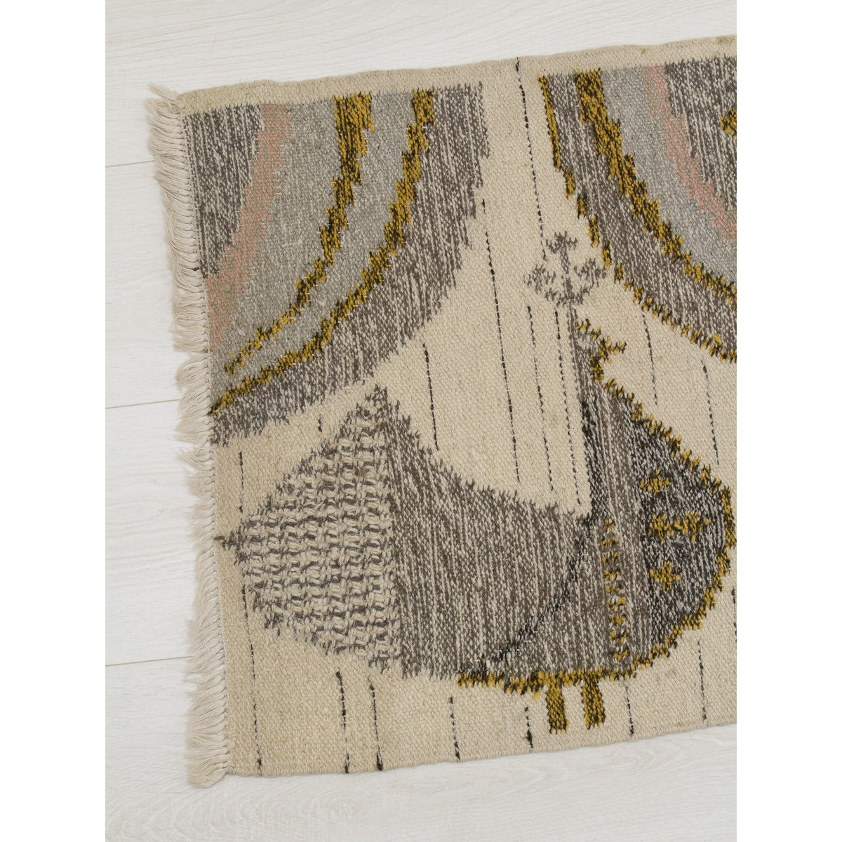 Close-up detail of the stylized peacock motif on the Eva Nemeth tapestry. The bird is handwoven in textured grey and white wool with harvest gold accents, showcasing the charming folk art influence of this vintage 1970s design.