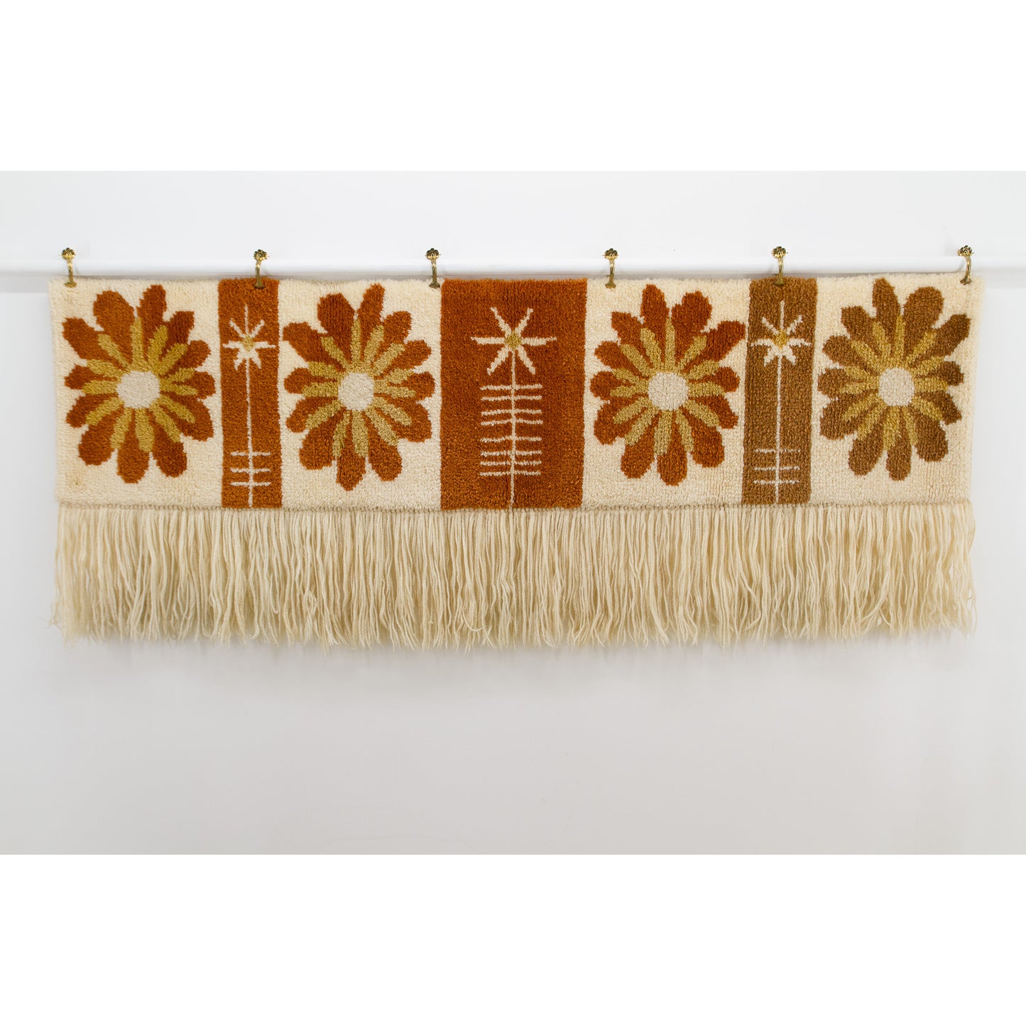 Full view of a large, rectangular vintage tapestry featuring four large retro daisy flowers in cognac, rust, and mustard yellow. 1970s Flower Power style.