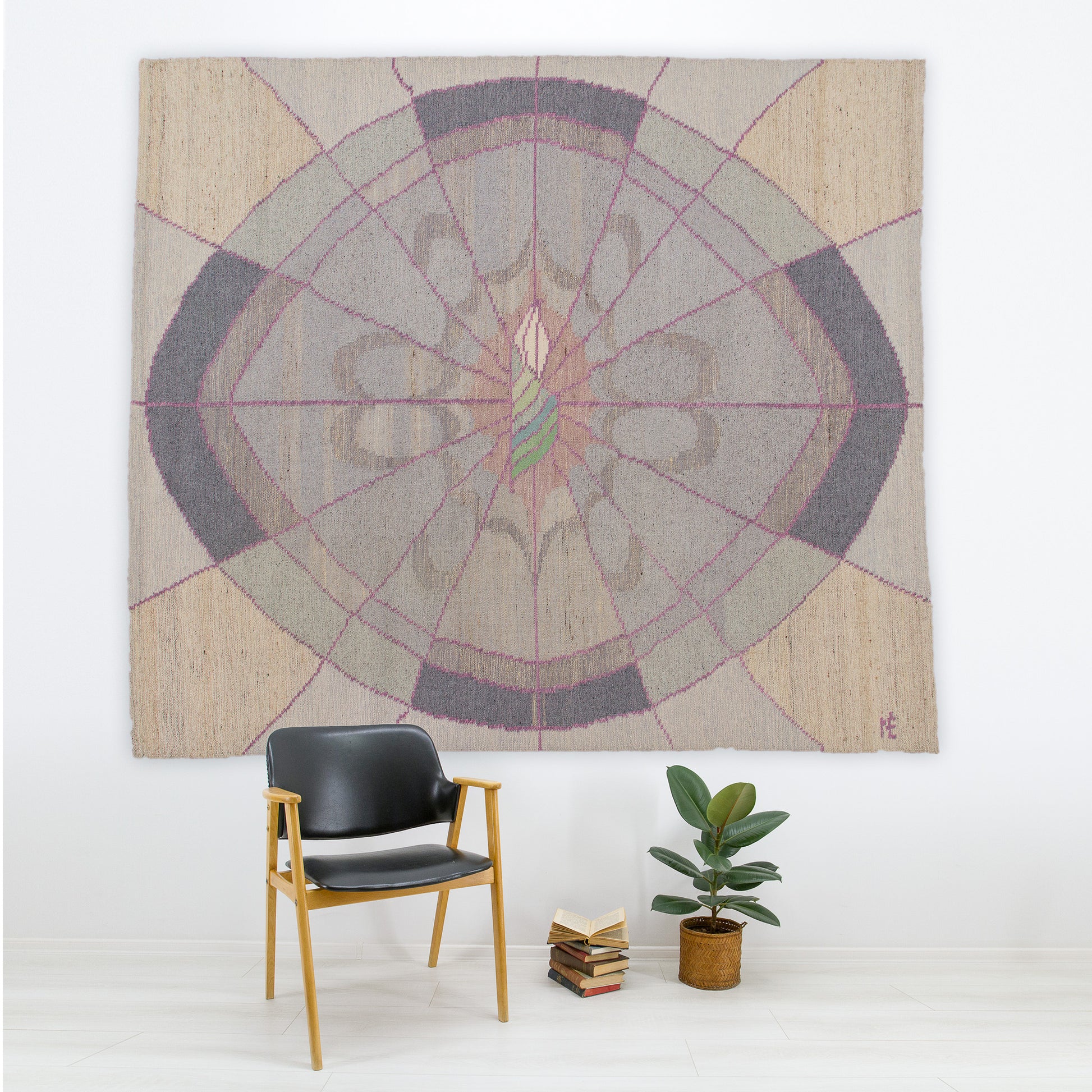 Massive vintage 1980s soft postmodern tapestry hanging in a minimalist office over a black leather chair. Dusty pink and grey geometric flatweave art by Eva Nemeth.
