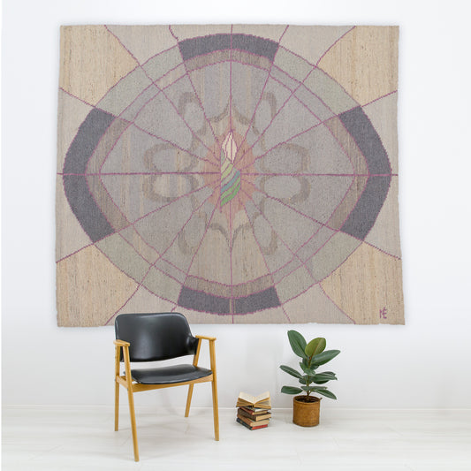 Massive vintage 1980s soft postmodern tapestry hanging in a minimalist office over a black leather chair. Dusty pink and grey geometric flatweave art by Eva Nemeth.