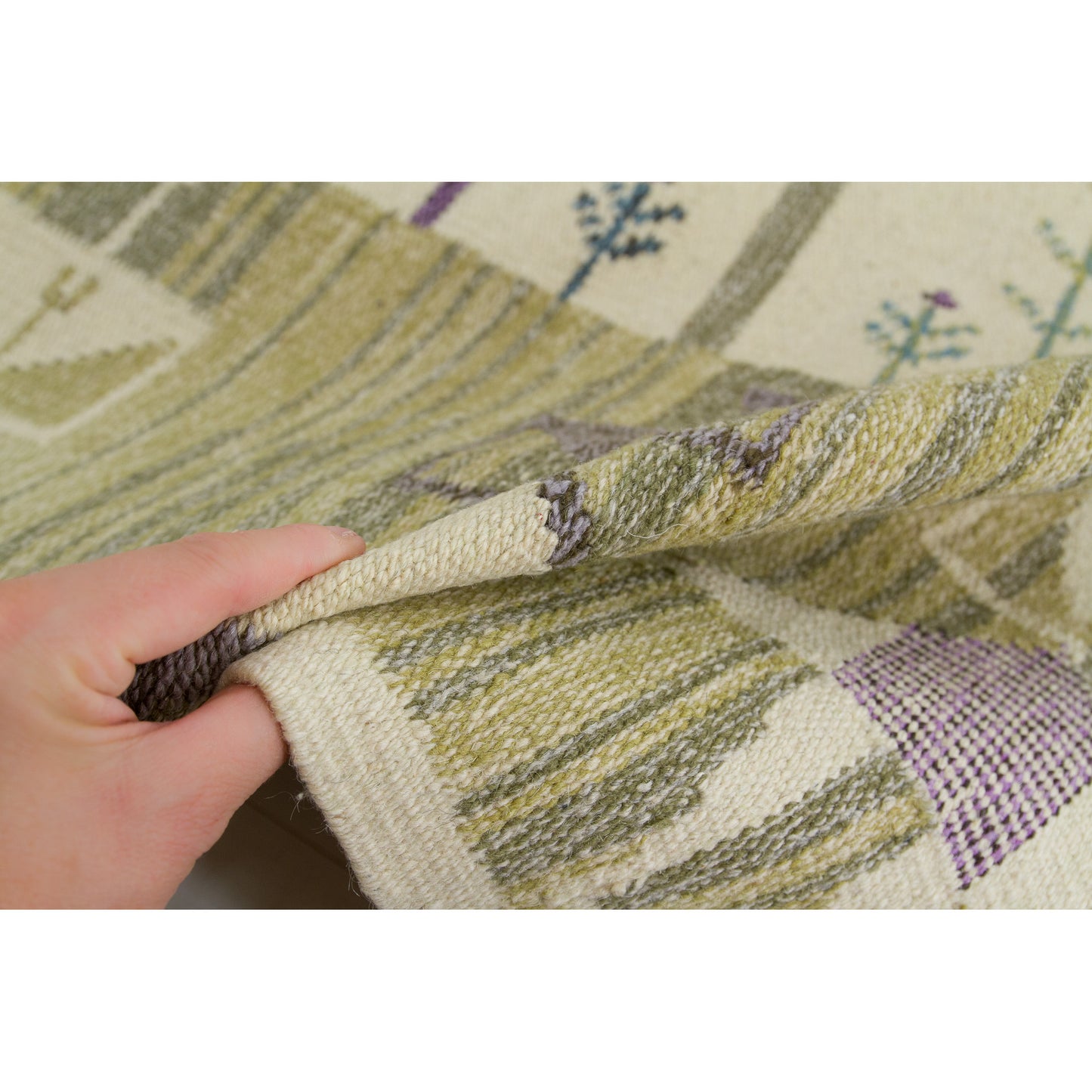 Hand holding a heavy 1970s wool wall hanging to demonstrate the beautifully soft but thick acoustic drapery and texture of the woven material.