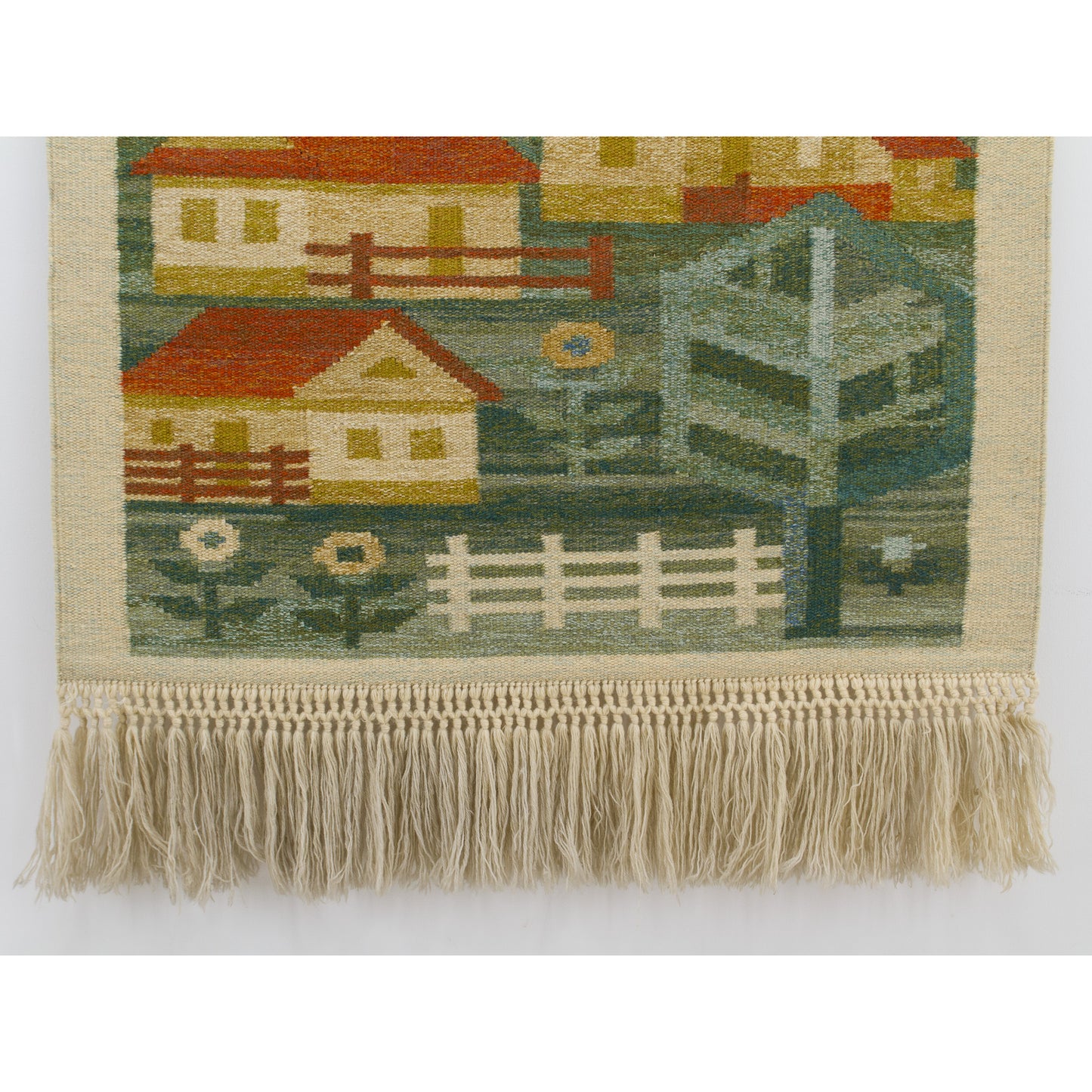 Detailed view capturing the lower village landscape blending into the meticulous, long hand-knotted beige and beige wool macrame fringes.