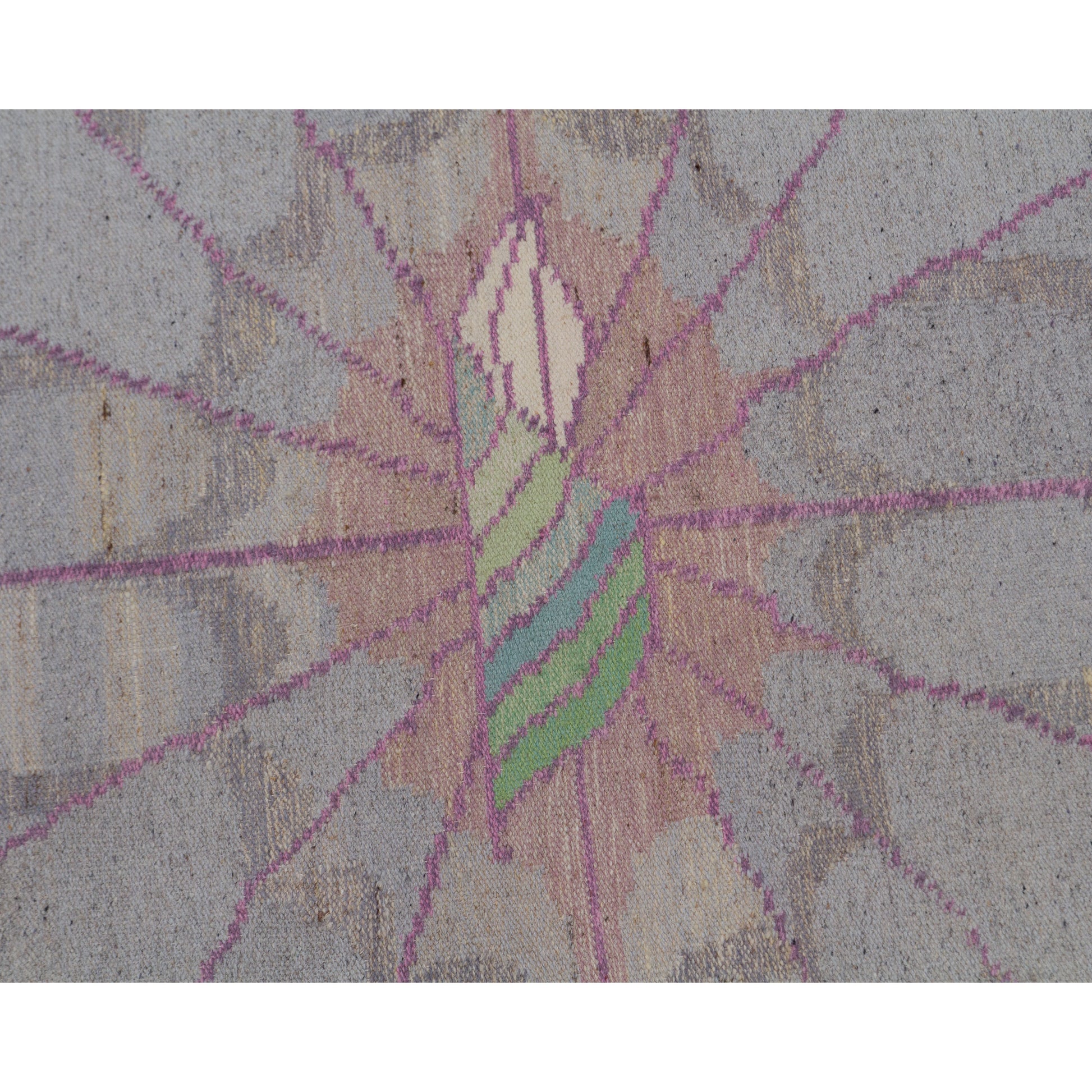 Close up on the center motif. A beautifully stylized organic flower shape framed by spiderweb-like intersecting pink woven lines on a soft dove-grey background.