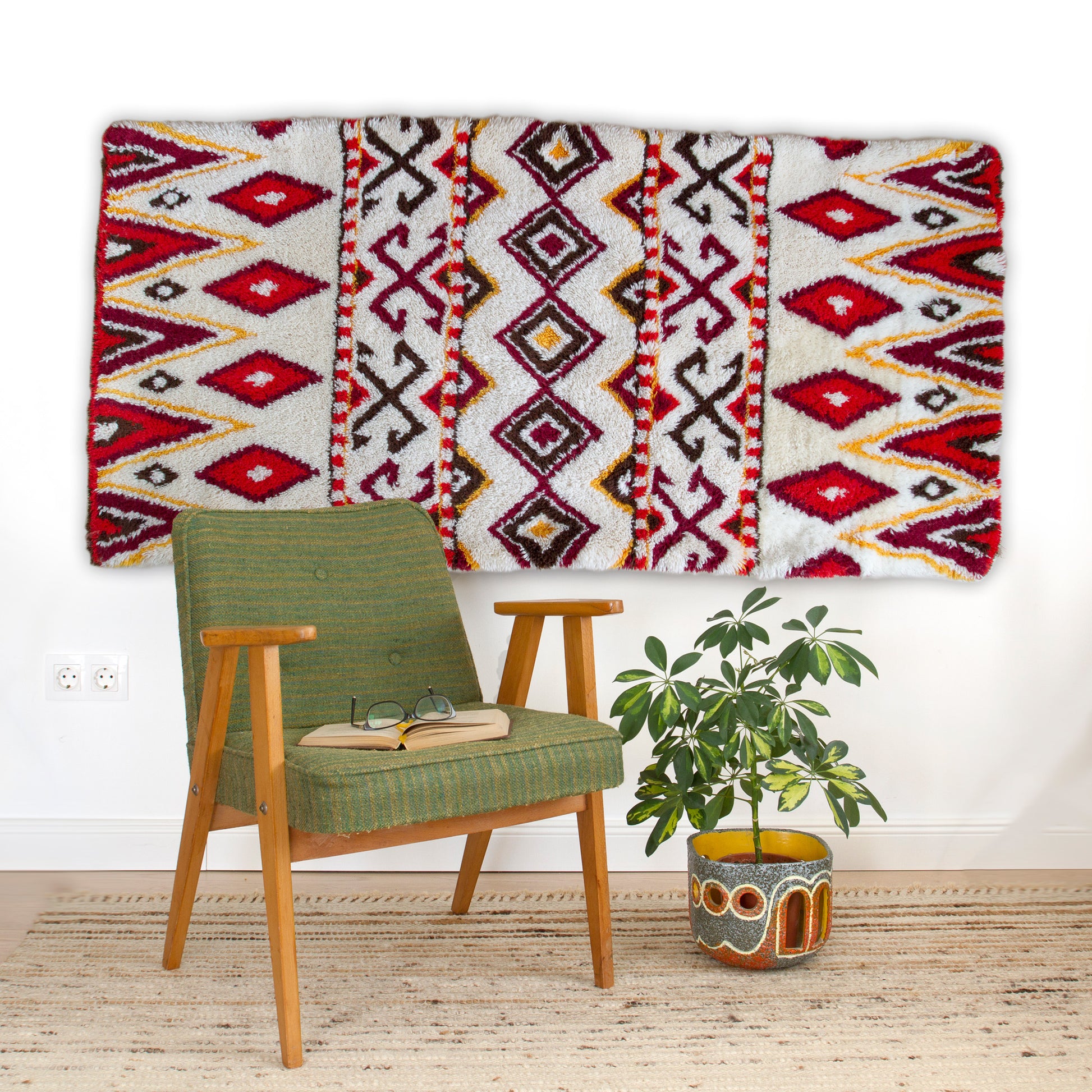Gorgeous interior design mockup styling the huge 72-inch textile hung majestically on a white wall behind a green mid-century armchair, functioning as spectacular soft wall art.