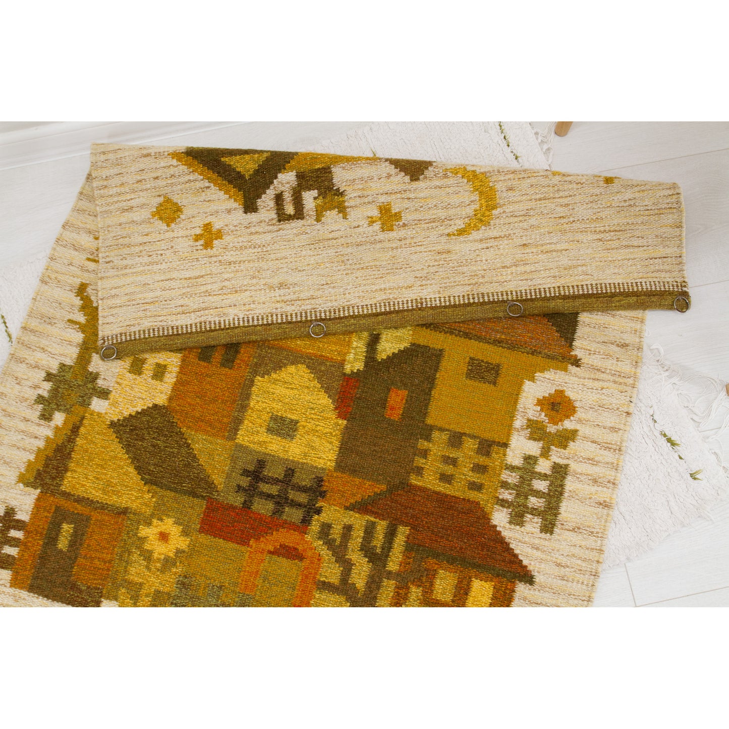 Flat-lay image revealing the tightly hemmed, professionally folded top edge showcasing small, durable metal rings carefully hand-sewn for easy immediate mounting.