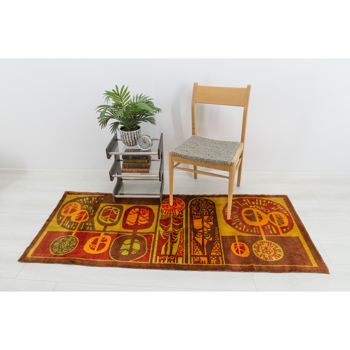 Interior layout styling the textile flat as a beautiful hallway floor rug positioned in front of a minimalist dining chair. Highly versatile room decoration.