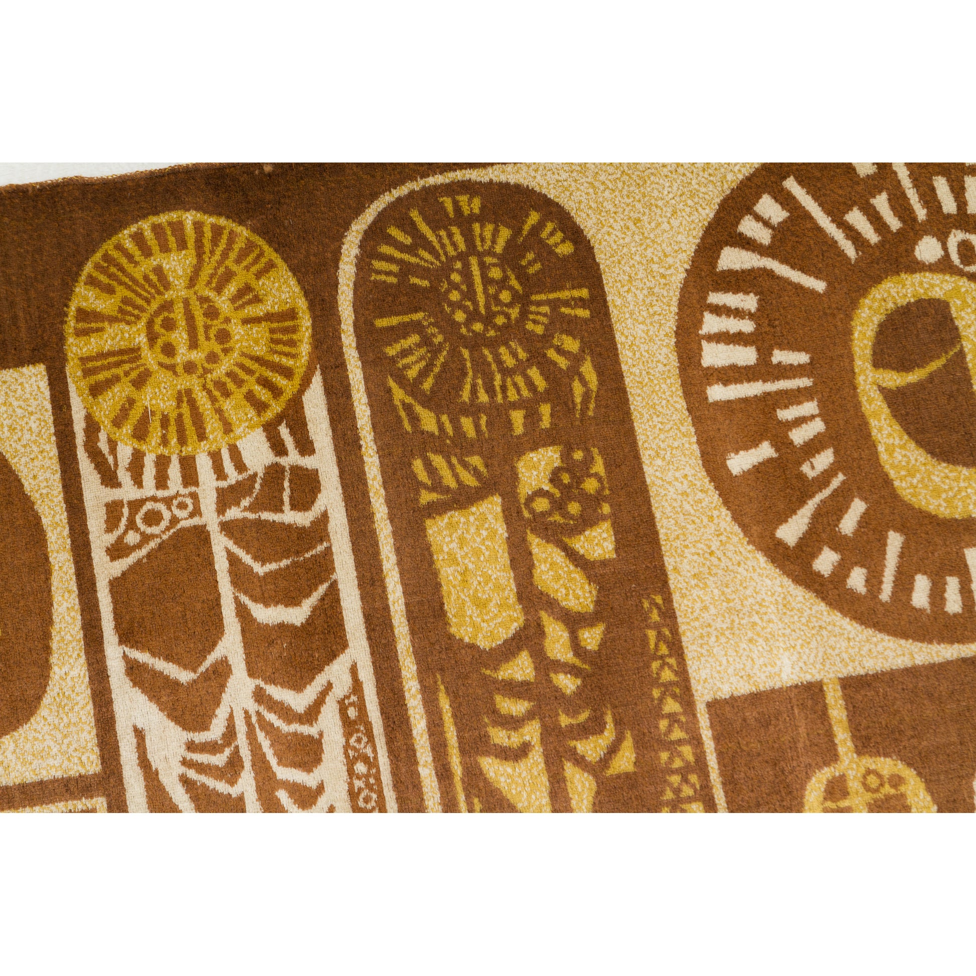Close-up of the right-side motif featuring radiating tree rings or stylized seed head patterns in harvest gold and chocolate brown. Graphic 1960s textile art.