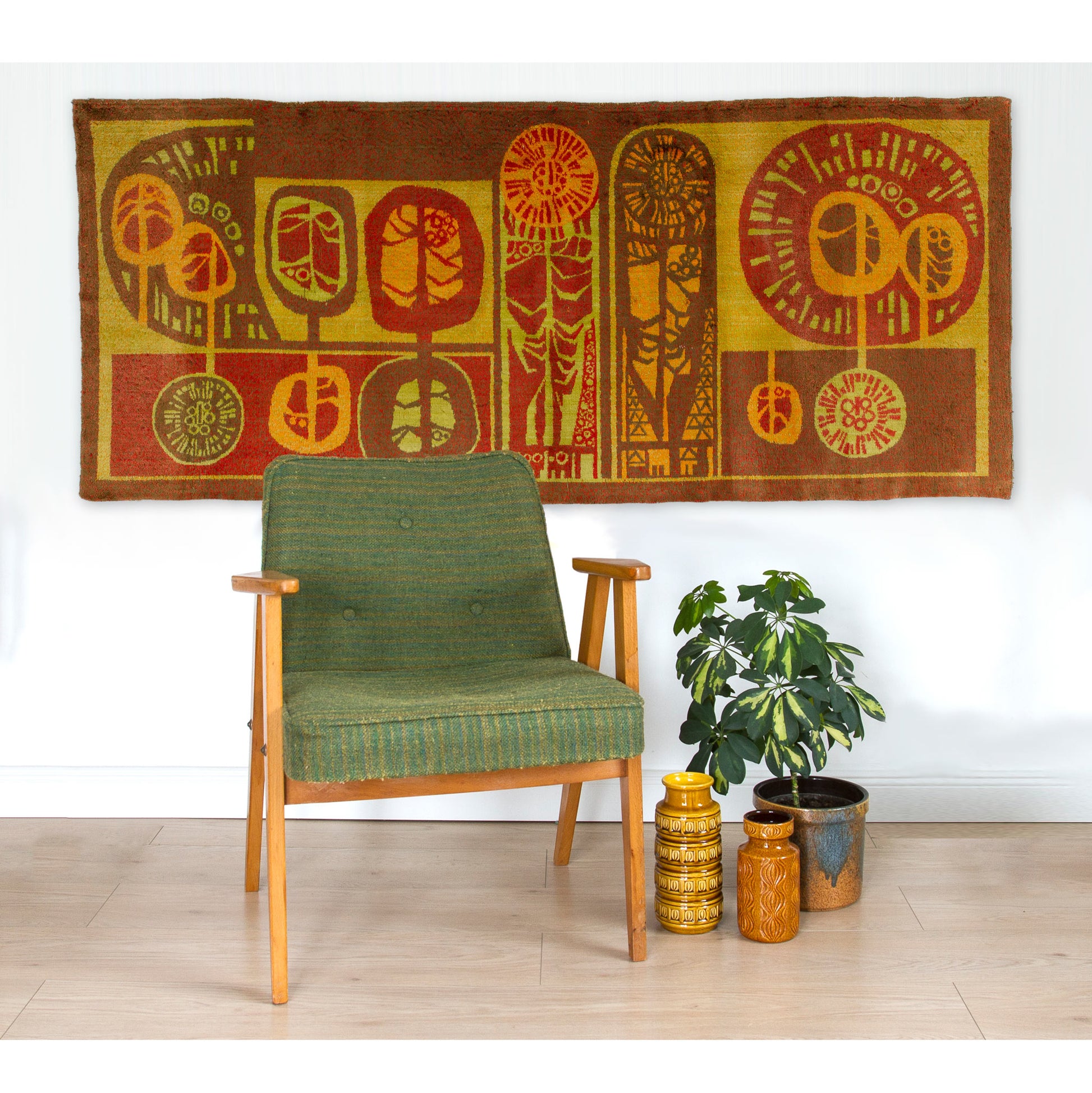 Vintage 60s home decor wall tapestry styled majestically behind a green mid-century armchair, showcasing its massive scale and warm golden brown palette.