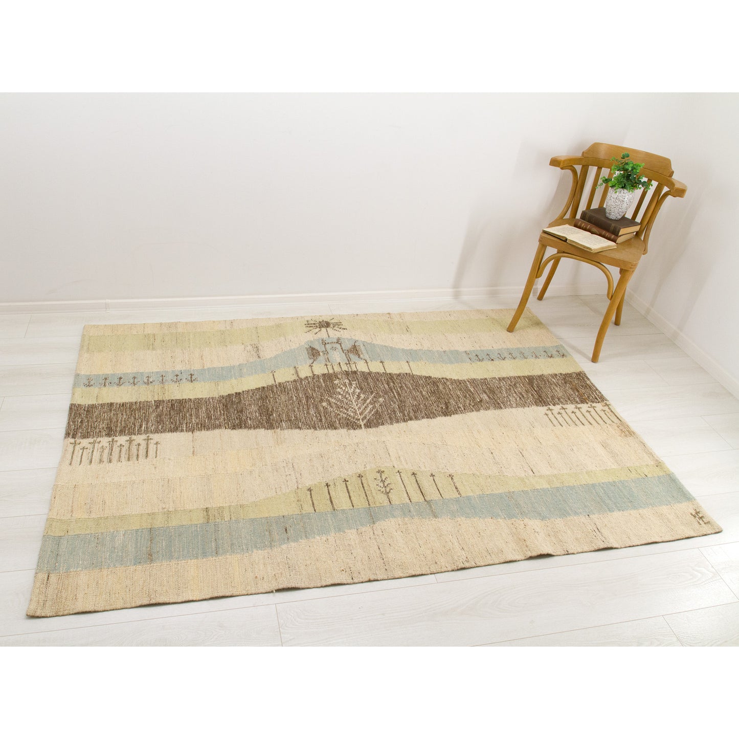 Large authentic Eva Nemeth handwoven wool rug styled on a light floor with a wooden corner chair. Showcasing its dual-purpose durability as a gorgeous, heavy-duty scandinavian rug for living spaces.
