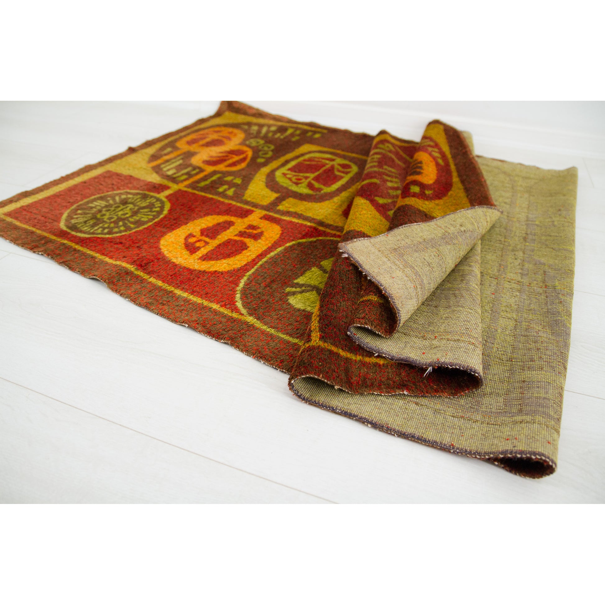 Abstract vintage wall hanging gathered and draped, highlighting that while the material is extremely tough and heavy, it possesses a supple, luxurious flow.