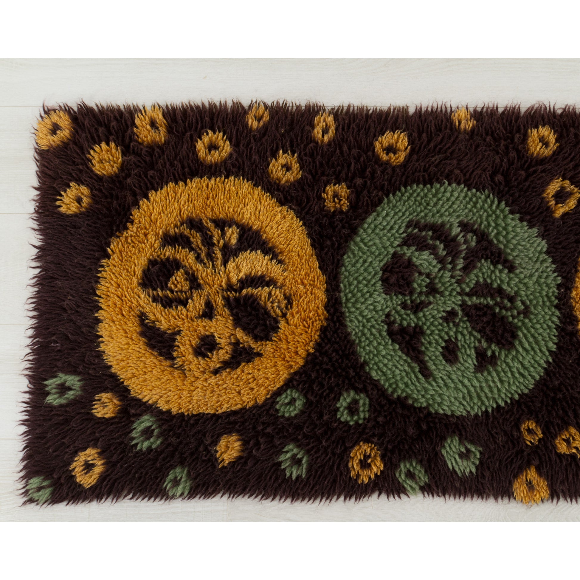 Clear photography of the left-hand section highlighting the crisp, vivid colors of the deep mustard yellow dots and circle forms securely knotted into the brown fabric base.