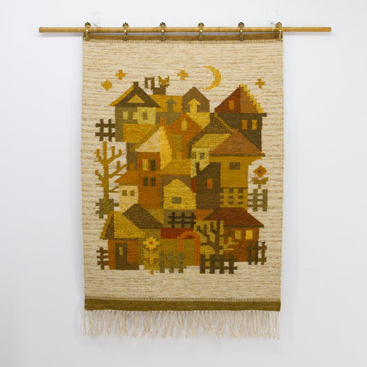 Straight on, un-obstructed flat lay view of the handwoven folk art tapestry showing a rustic stylized townscape under an amber yellow moon.