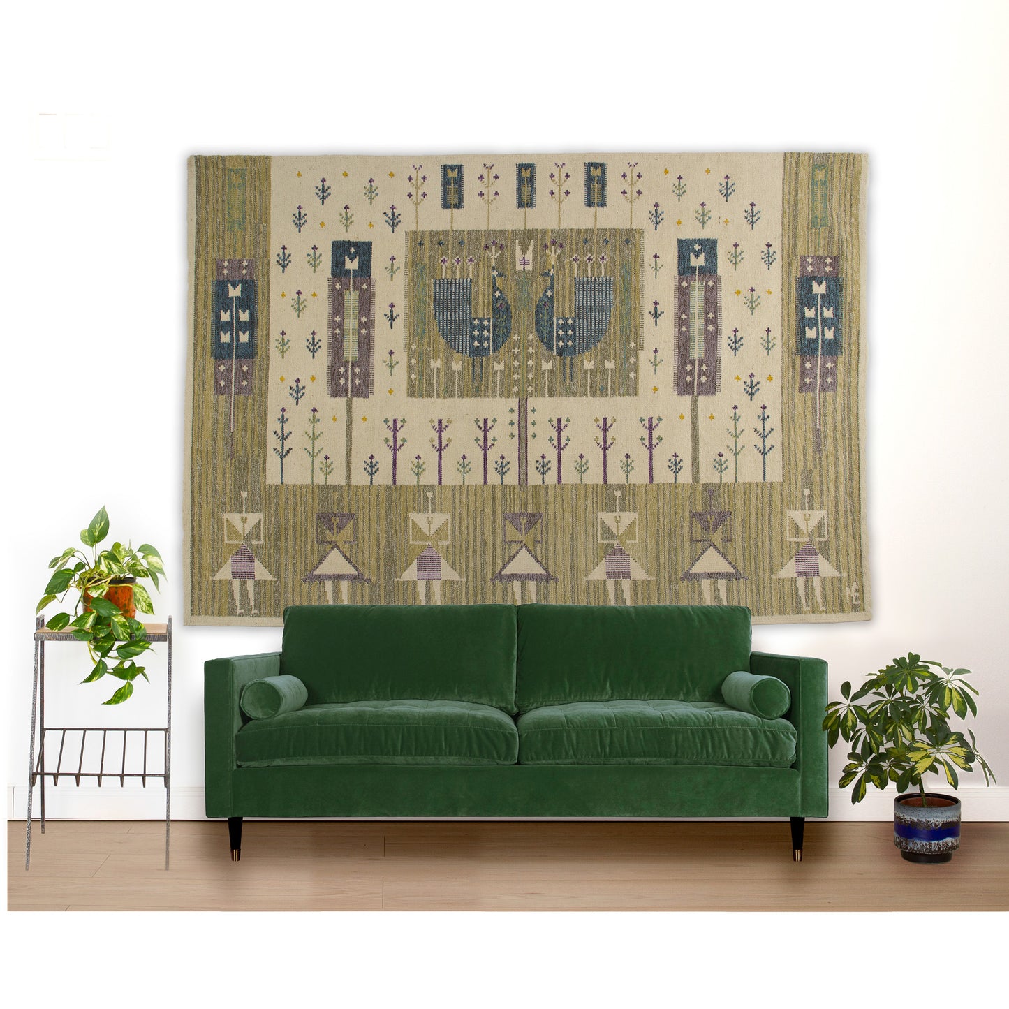 Monumental Eva Nemeth mid-century tapestry hung as dramatic oversized wall art behind a large forest green velvet sofa.