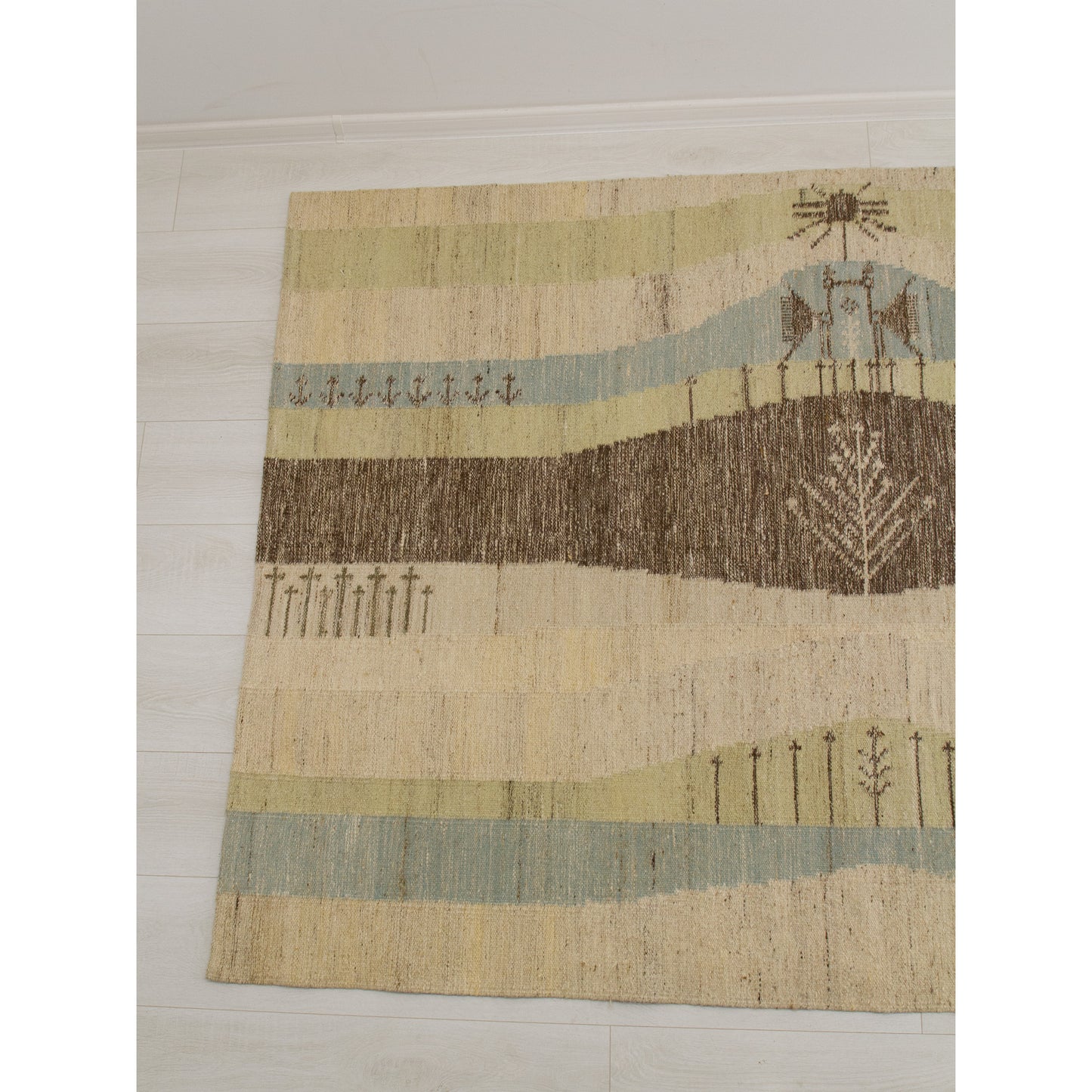 The left panel of the tapestry wall hanging featuring a serene abstract geometric landscape with stylized trees and calm pastel blue, muted green, and soft brown tones.