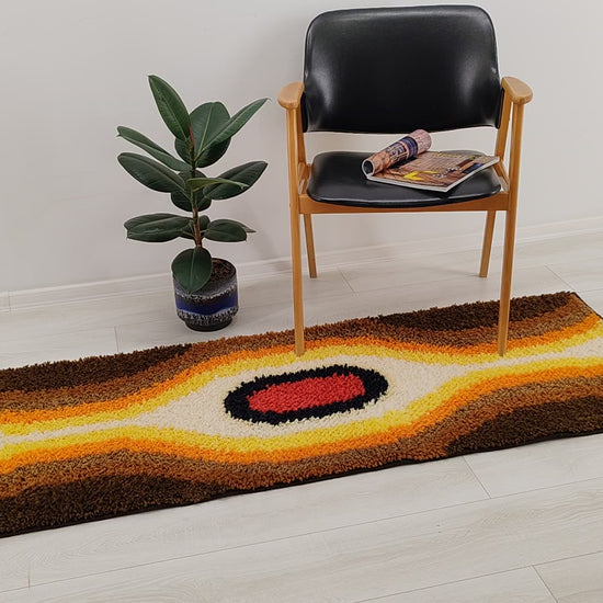 Smooth video pan of the multi-purpose vintage shag rug, demonstrating its tactile soft pile surface and the heavy duty woven backing.