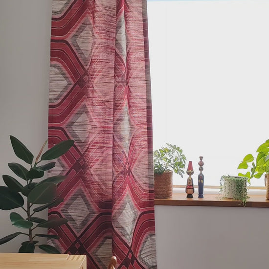 Vintage 1970s red geometric woven fabric panel hanging as a curtain, with a close look at the heavy textured weave in the light