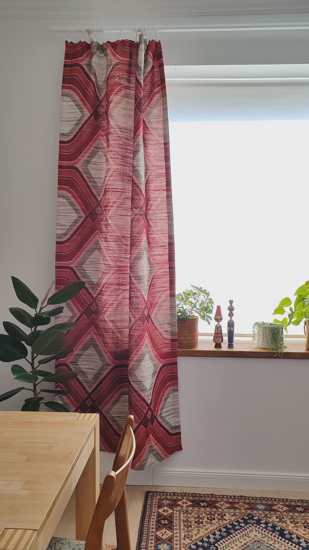 Vintage 1970s red geometric woven fabric panel hanging as a curtain, with a close look at the heavy textured weave in the light